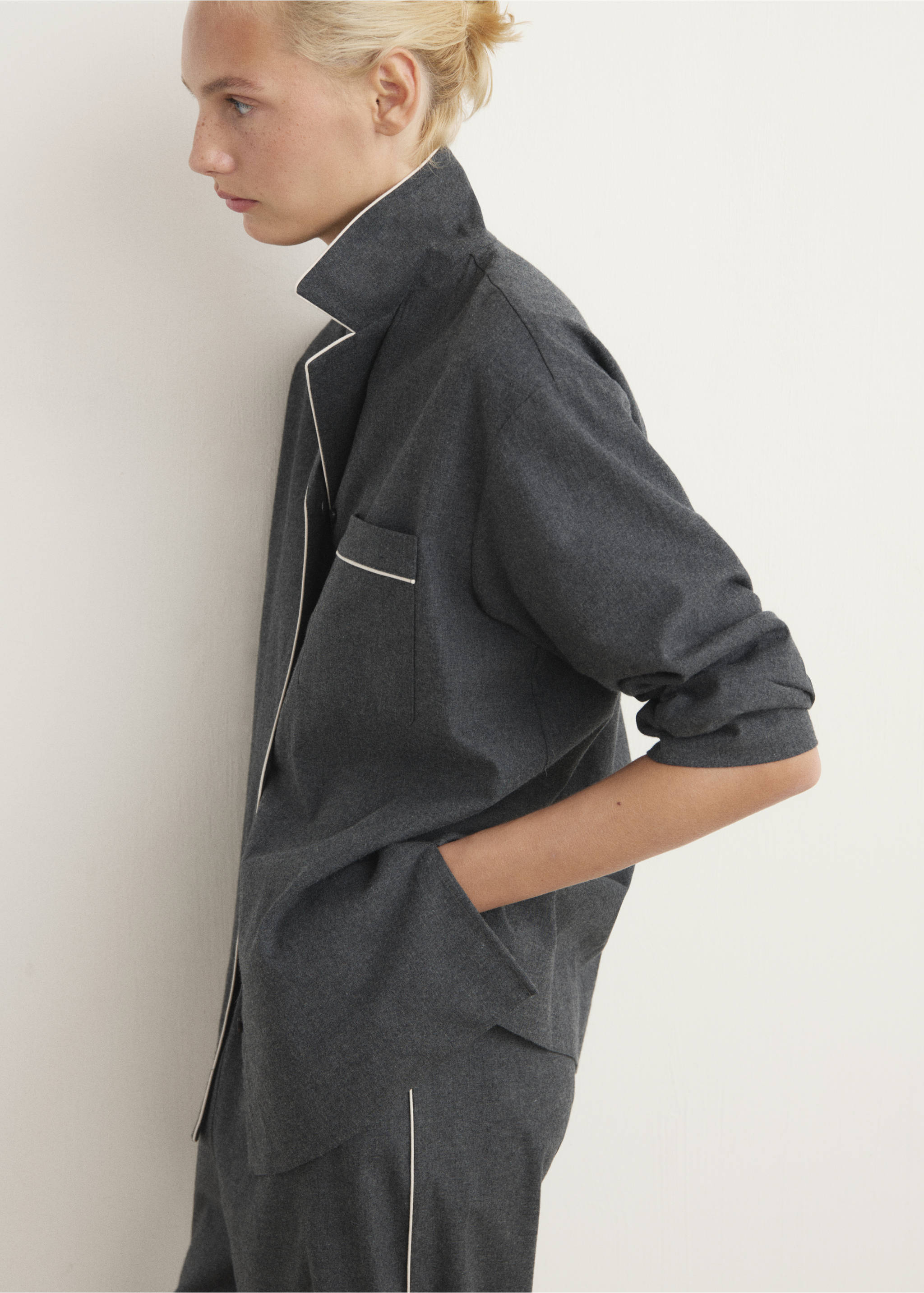 Dark grey pyjama trousers with white piping detail, shown in a close-up., Charcoal. Ref: 17017130-00.
