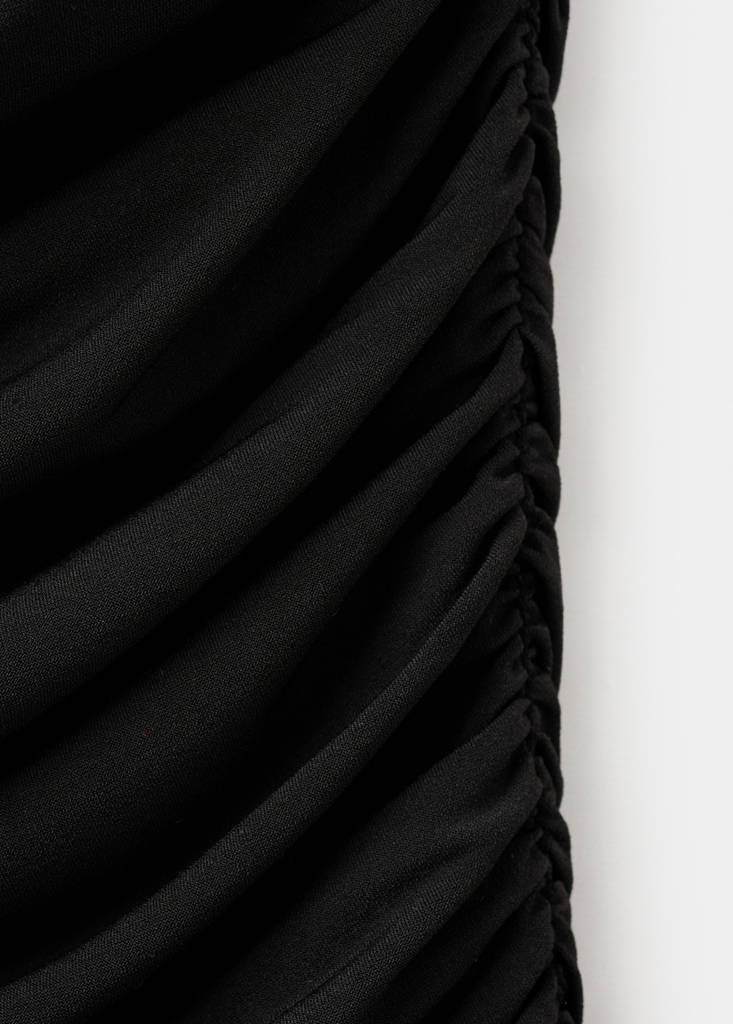 Ruched asymmetrical top with ruffle trim — Black