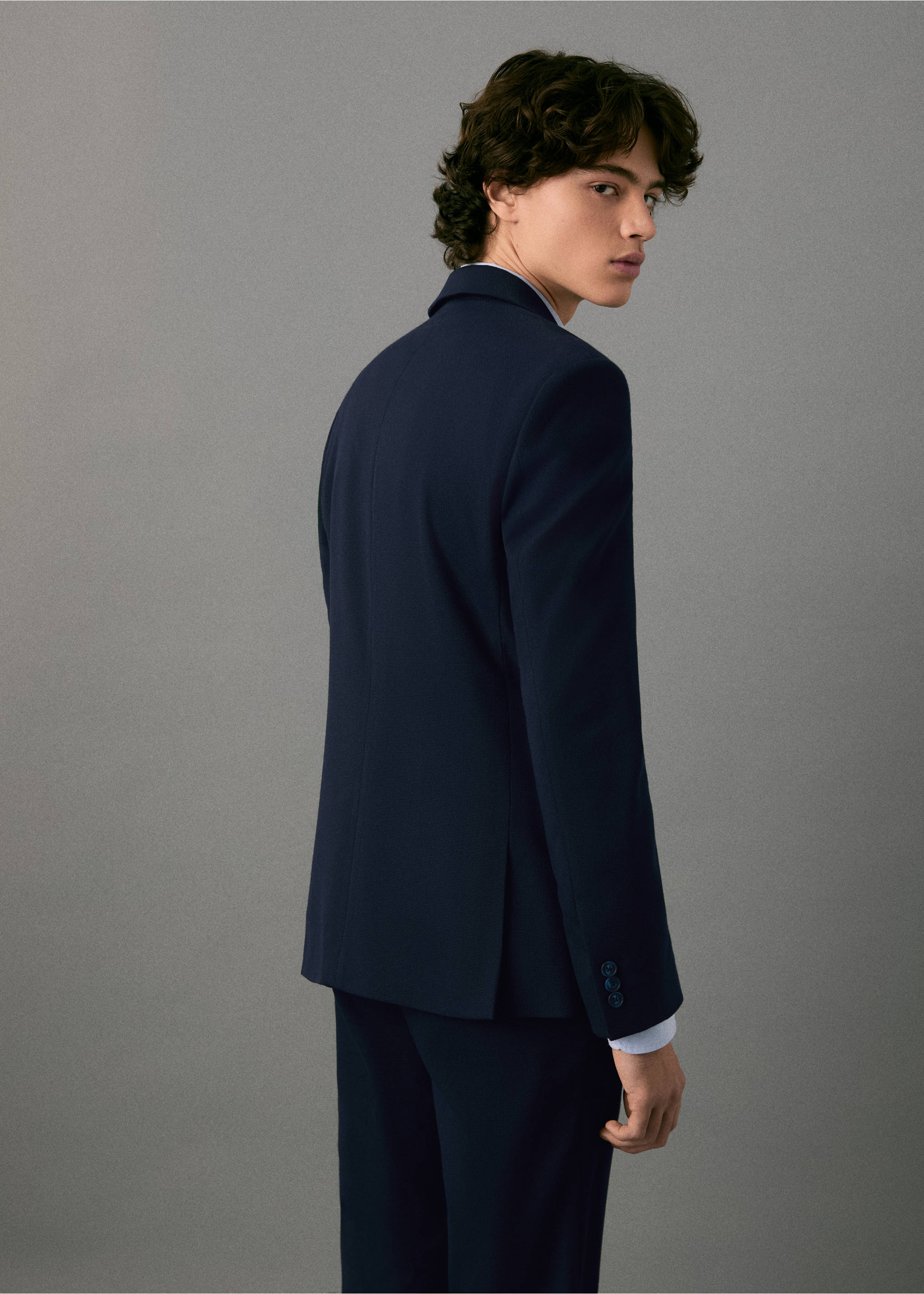 Navy blue blazer shown from the back on a model., Navy. Ref: 17027140-00.
