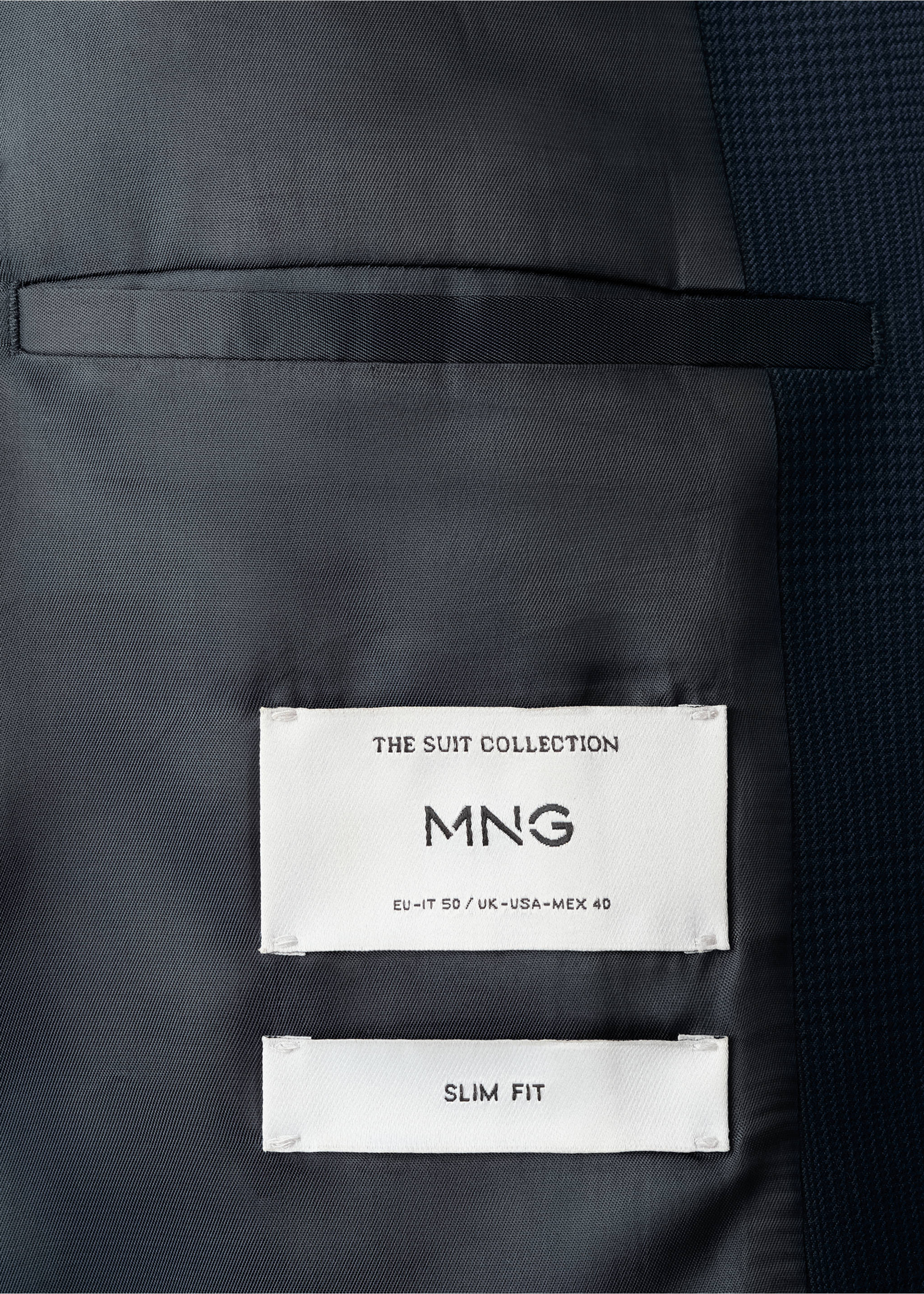 Close-up of the interior lining and labels of a navy blue blazer., Navy. Ref: 17027140-00.
