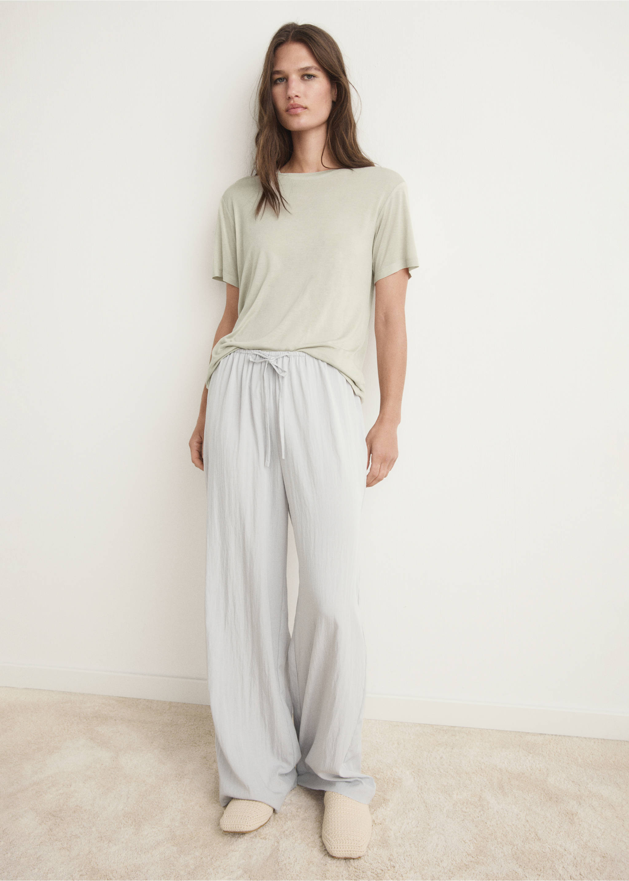 Pale green short-sleeved pyjama t-shirt worn with light grey relaxed trousers., Pastel Green. Ref: 17034105-00.