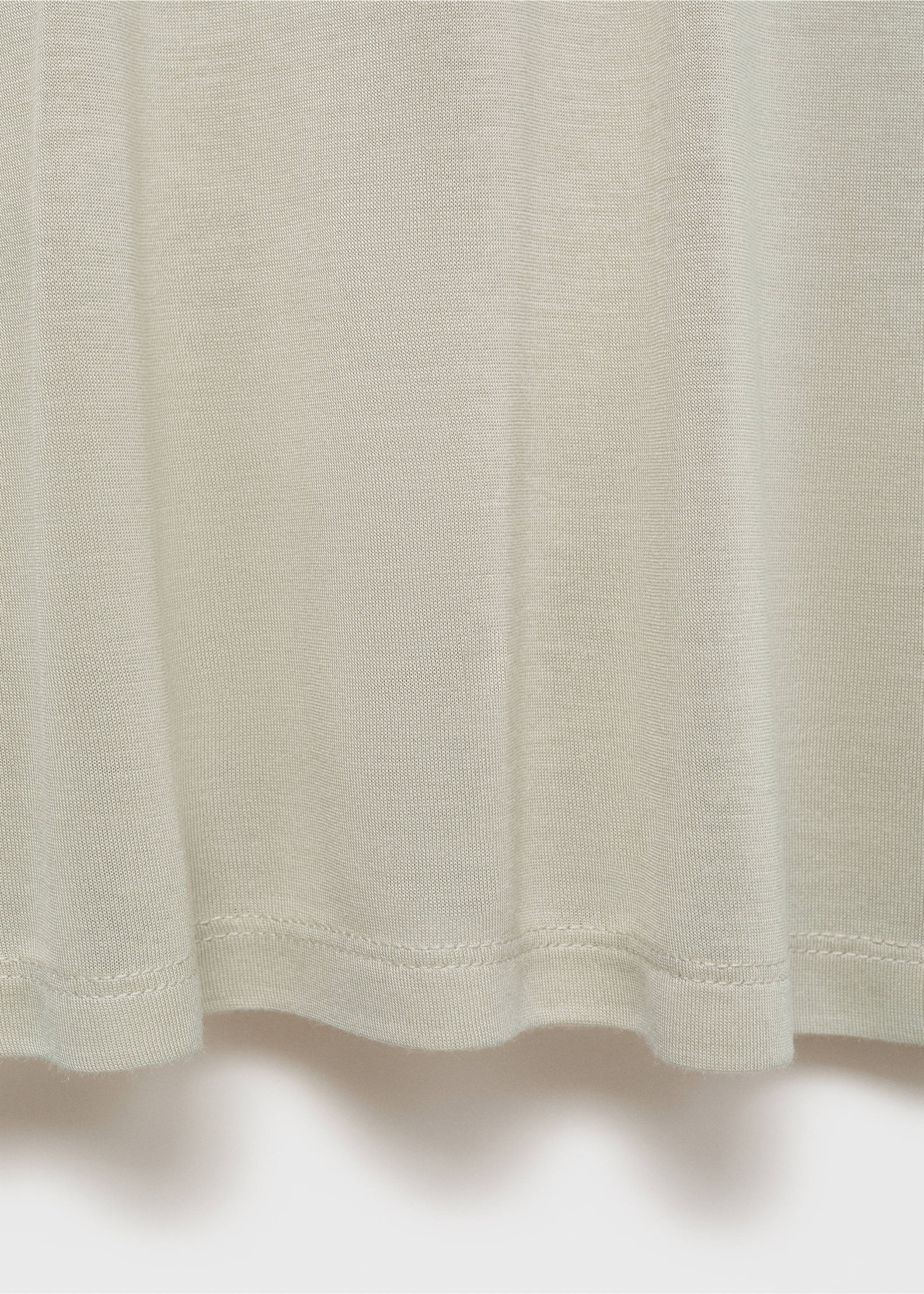 Close-up of the fine-gauge knit fabric and hem of a light beige pyjama t-shirt., Pastel Green. Ref: 17034105-00.