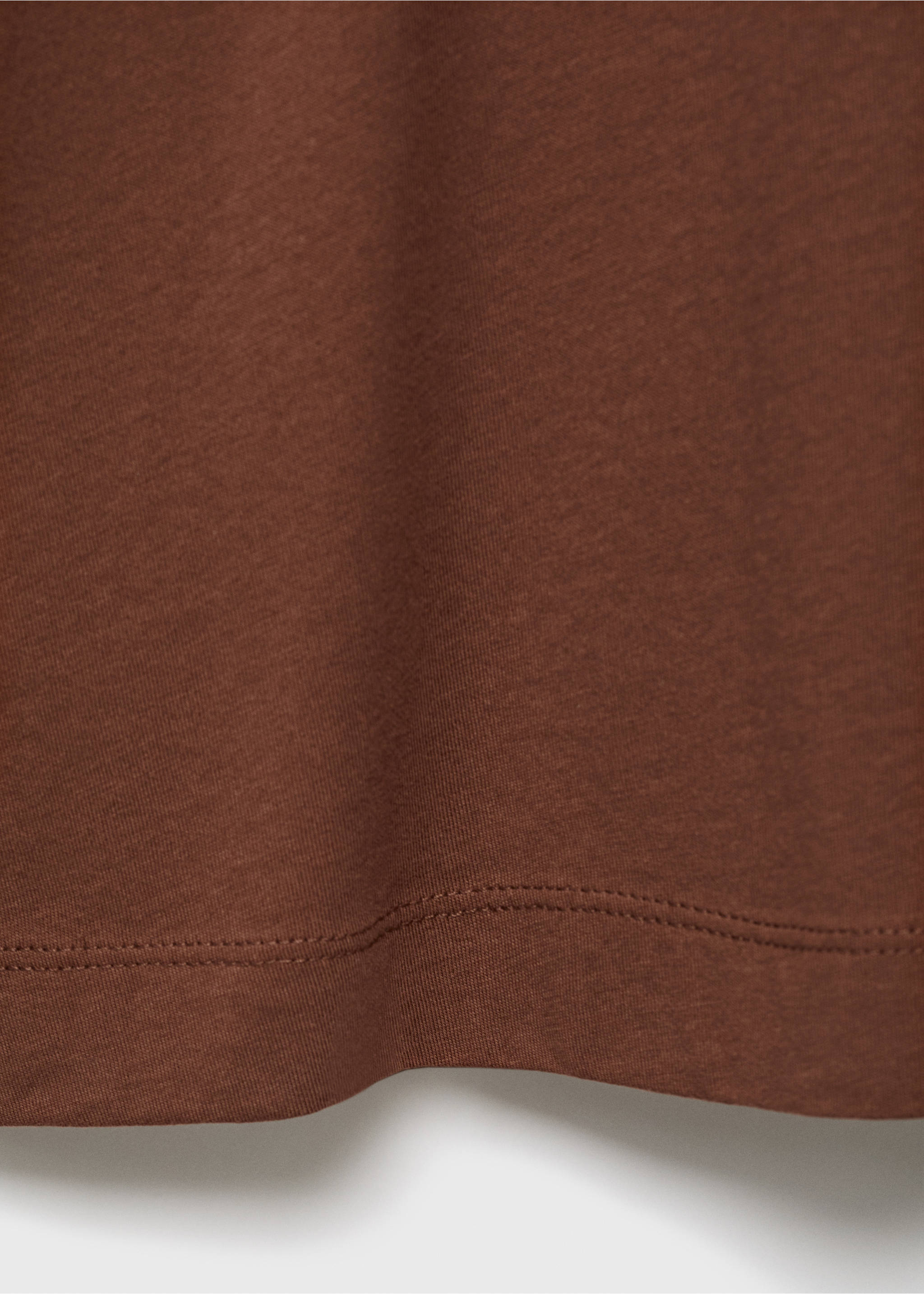 Close-up of the hem and fabric texture of a brown pyjama T-shirt., Brown. Ref: 17034112-00.