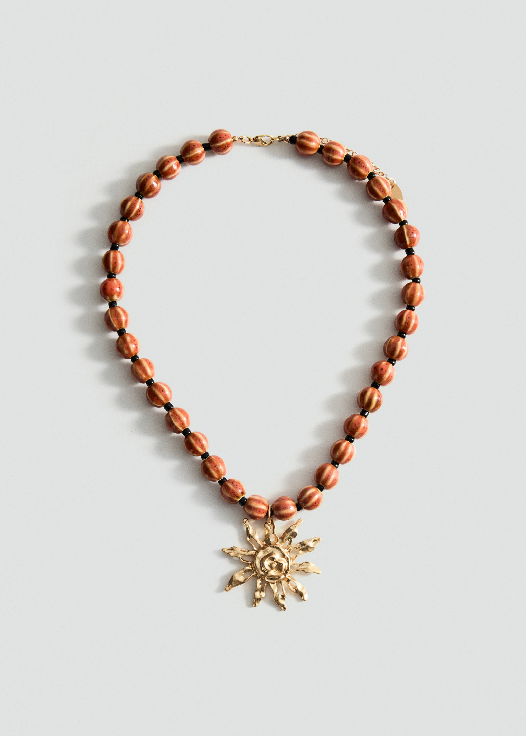 Collier boules en céramique avec pendentif soleil - Article sans modèle