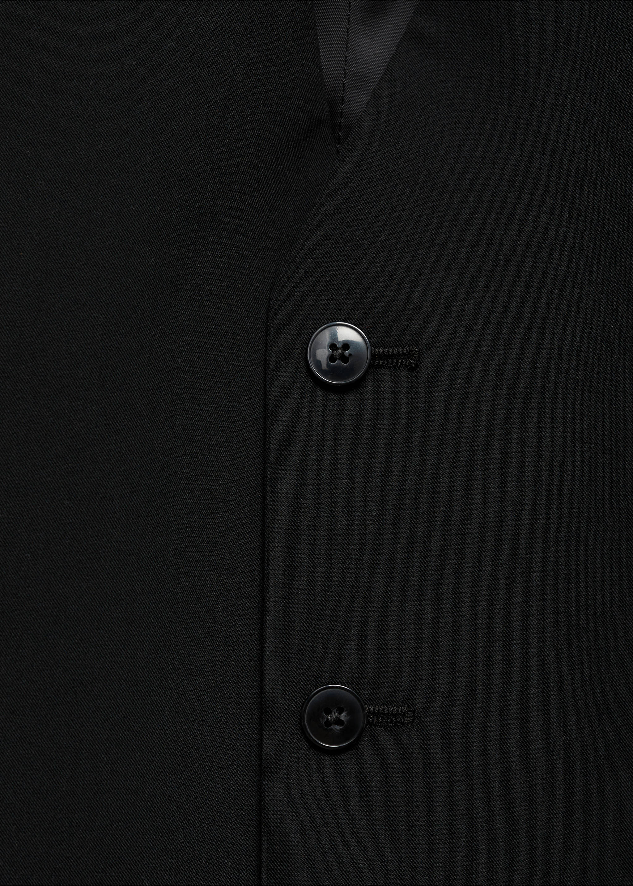 Close-up of a black waistcoat showing the front button fastening., Black. Ref: 17051236-00.
