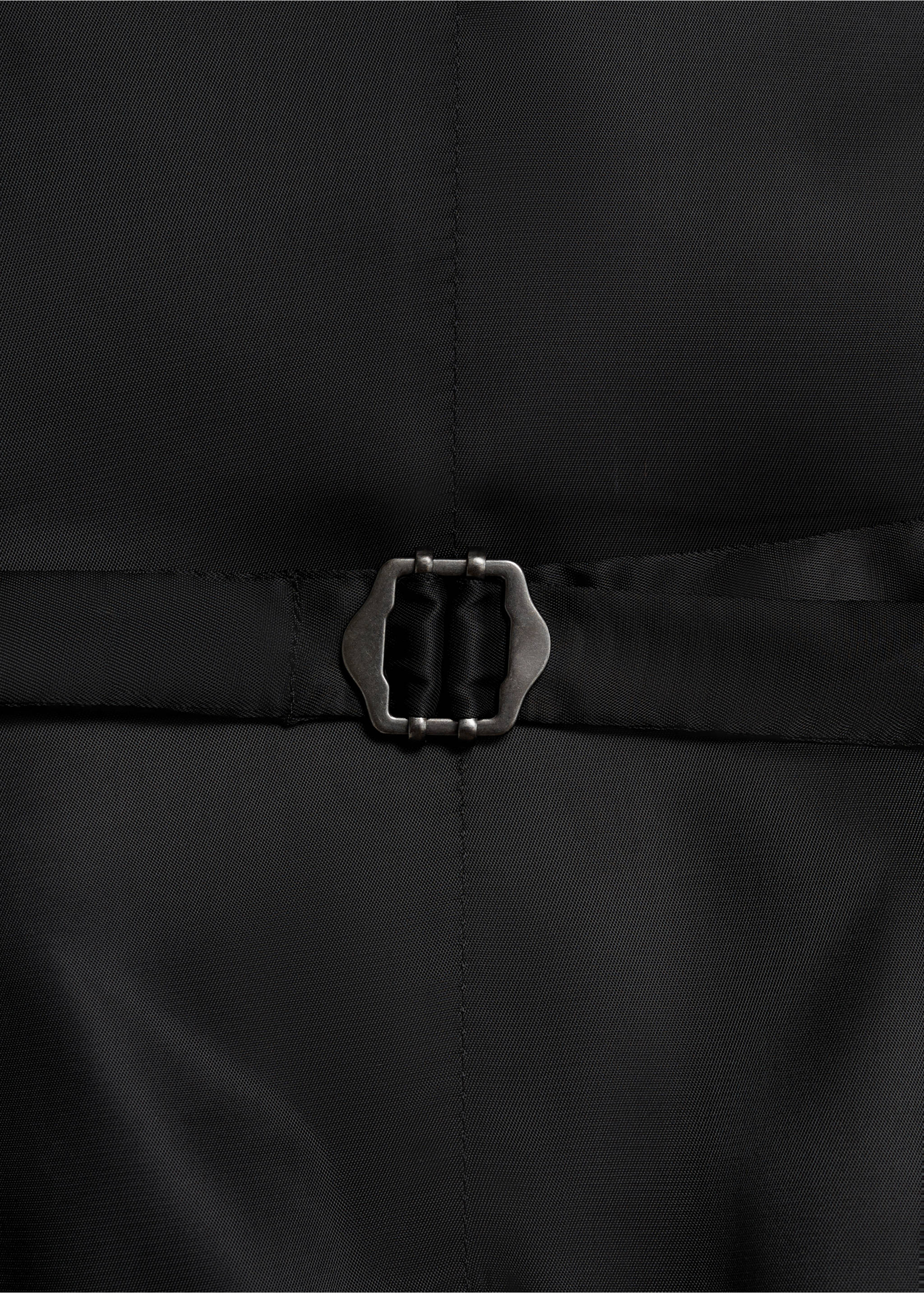Close-up of the black waistcoat fabric and back adjustable buckle., Black. Ref: 17051236-00.