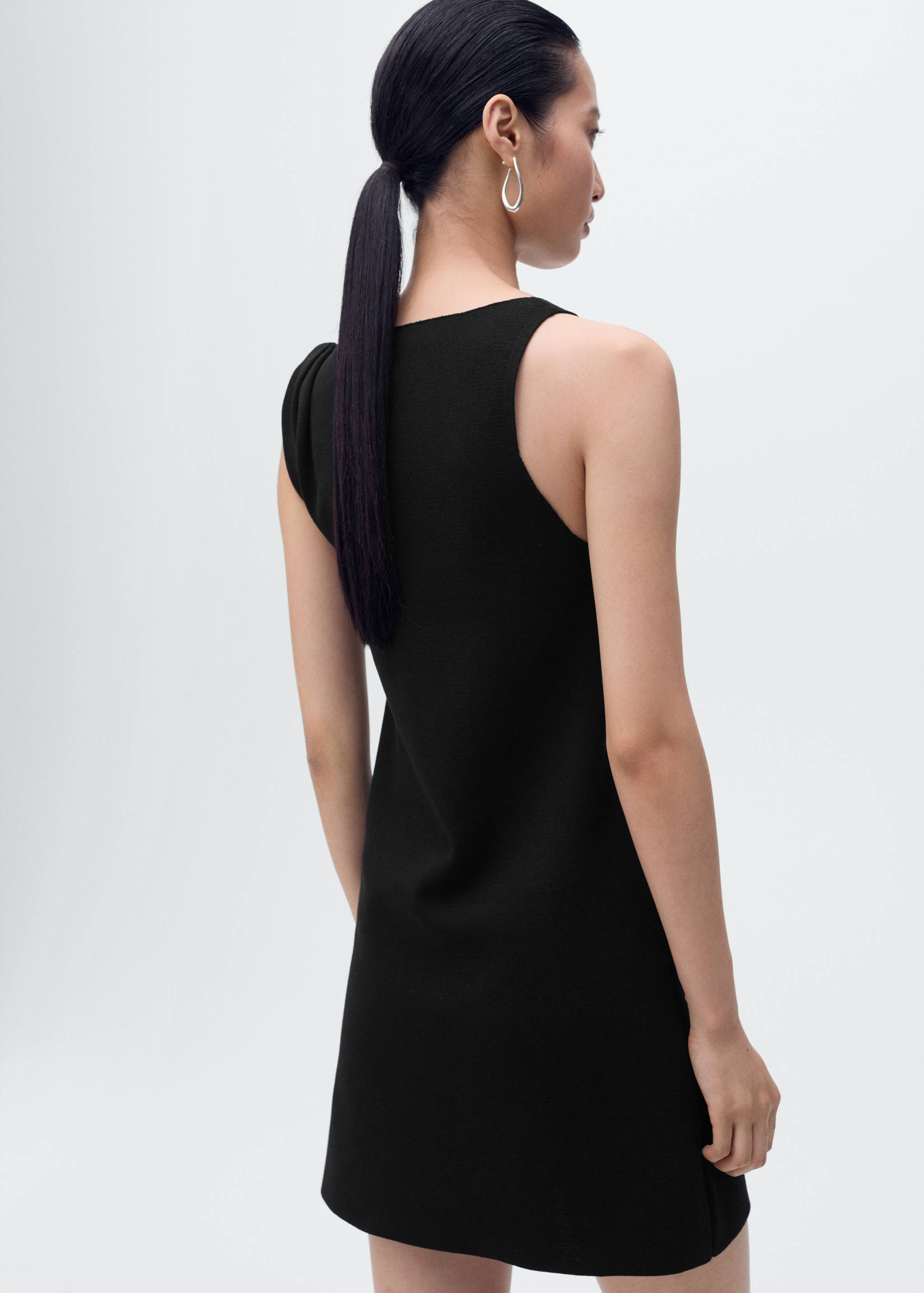 Asymmetrical knitted dress with strap - Reverse of the article