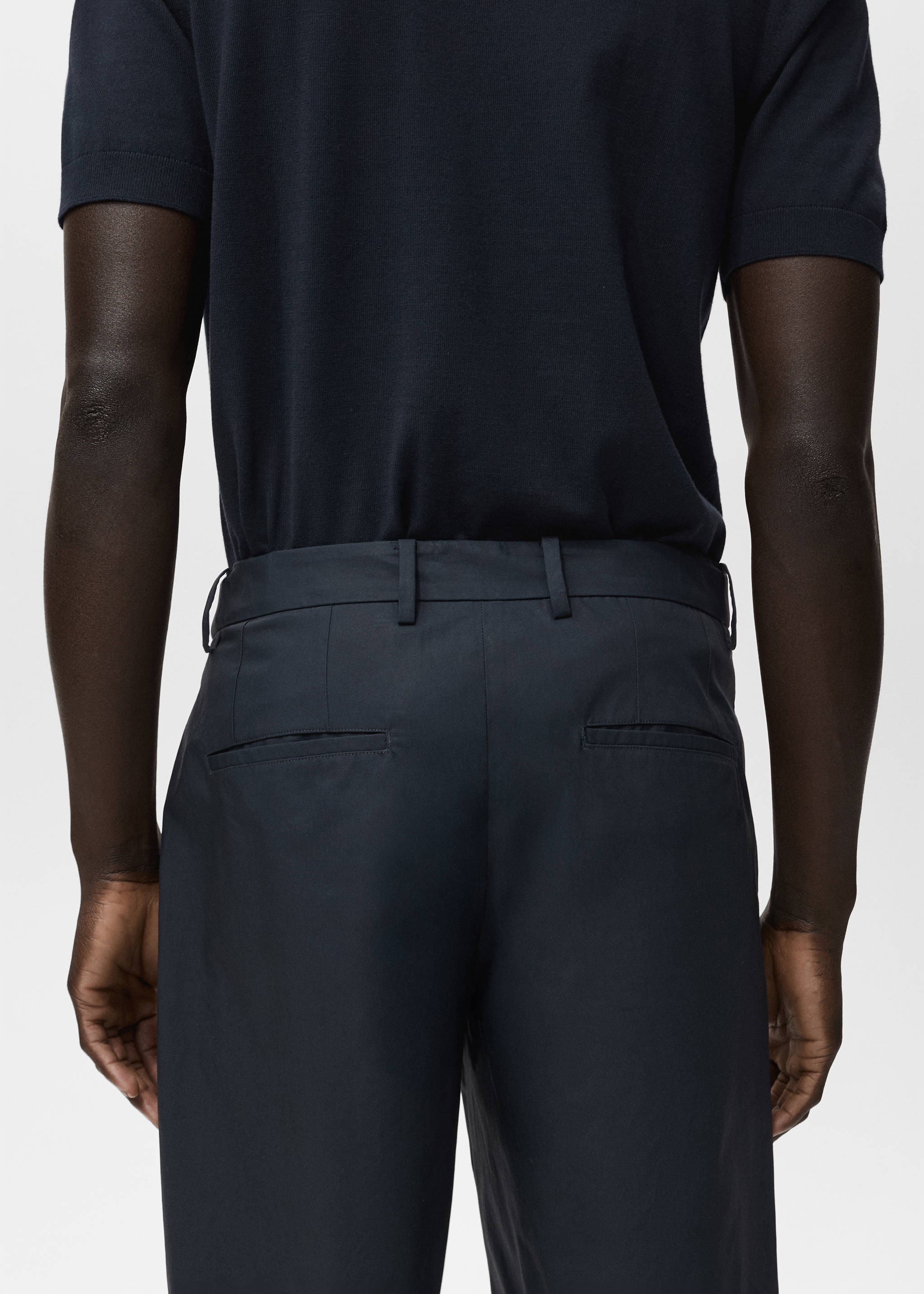 Dark navy blue bermuda shorts viewed from the back, worn with a tucked-in navy knit polo., Navy. Ref: 17081161-00.