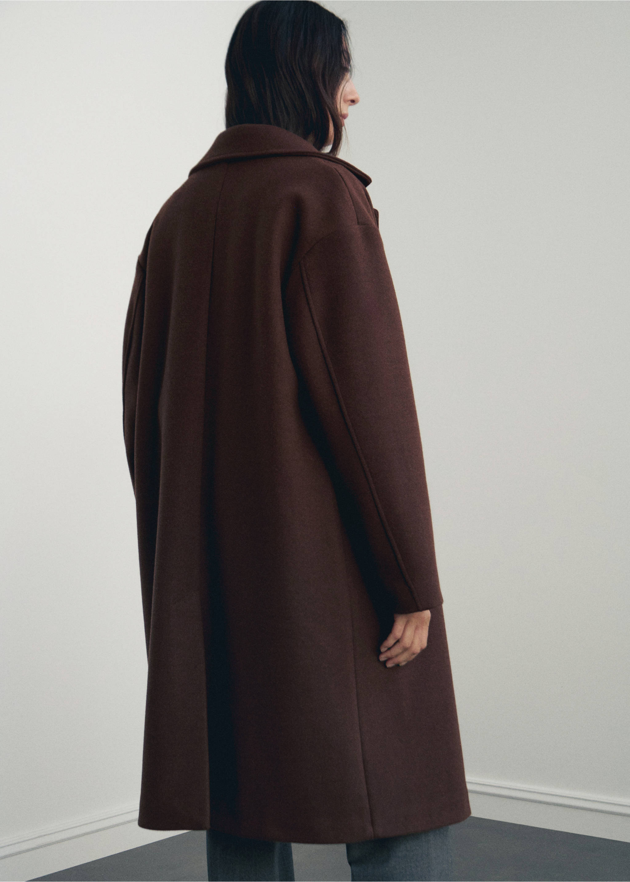 Dark brown long coat with lapel collar and drop shoulders, shown from behind., Brown. Ref: 17095812-00.