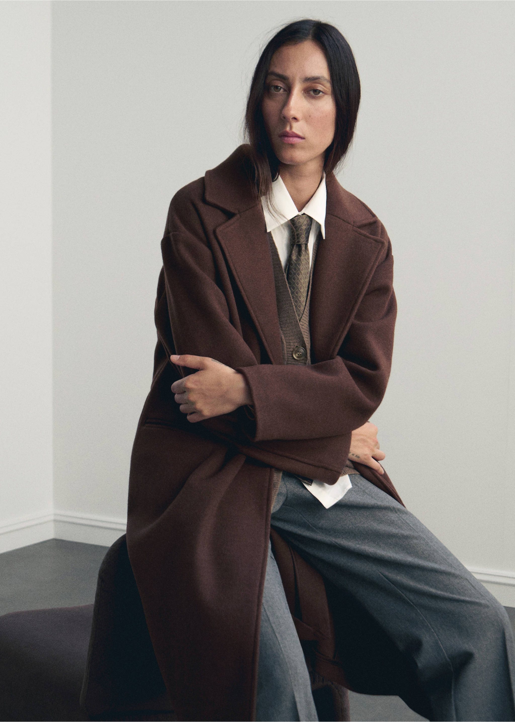 Dark brown coat with wide lapels worn over a white shirt and vest., Brown. Ref: 17095812-00.