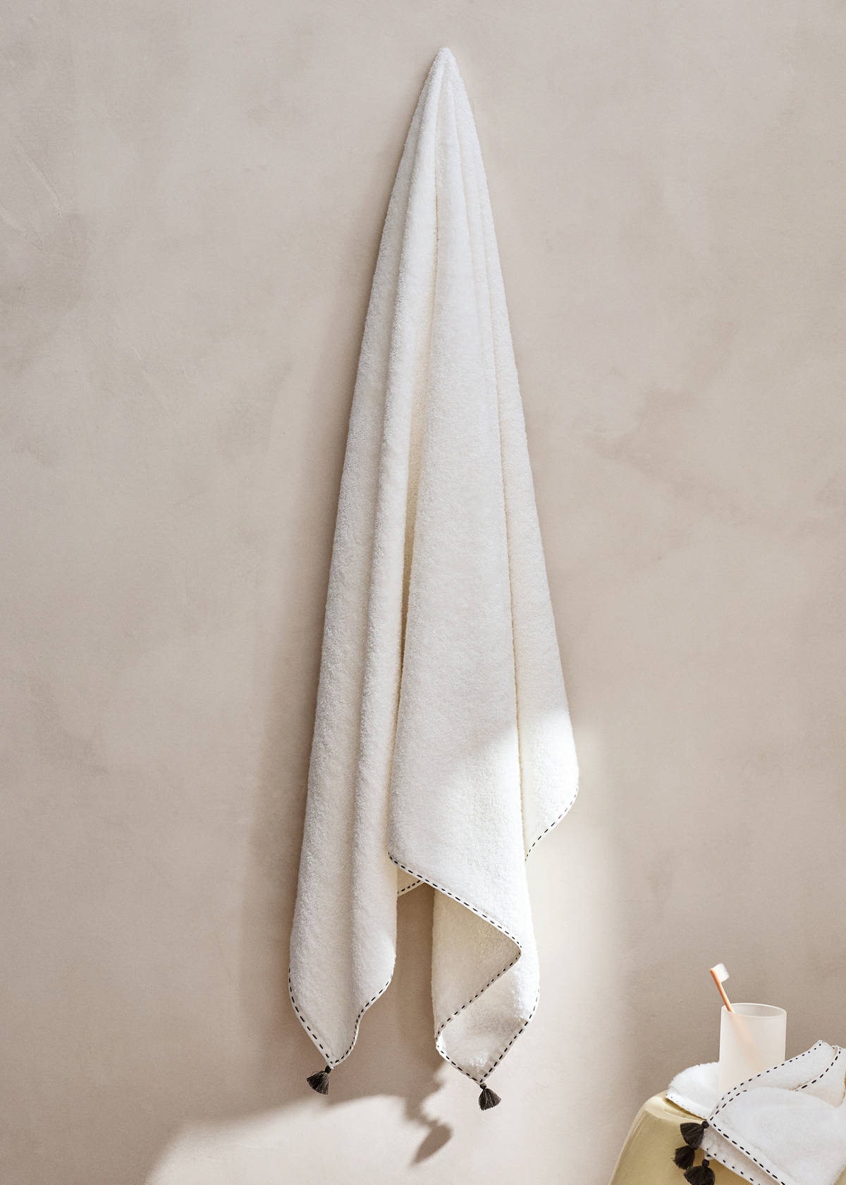 Bath towel with topstitch finish and pompom detail — Off White