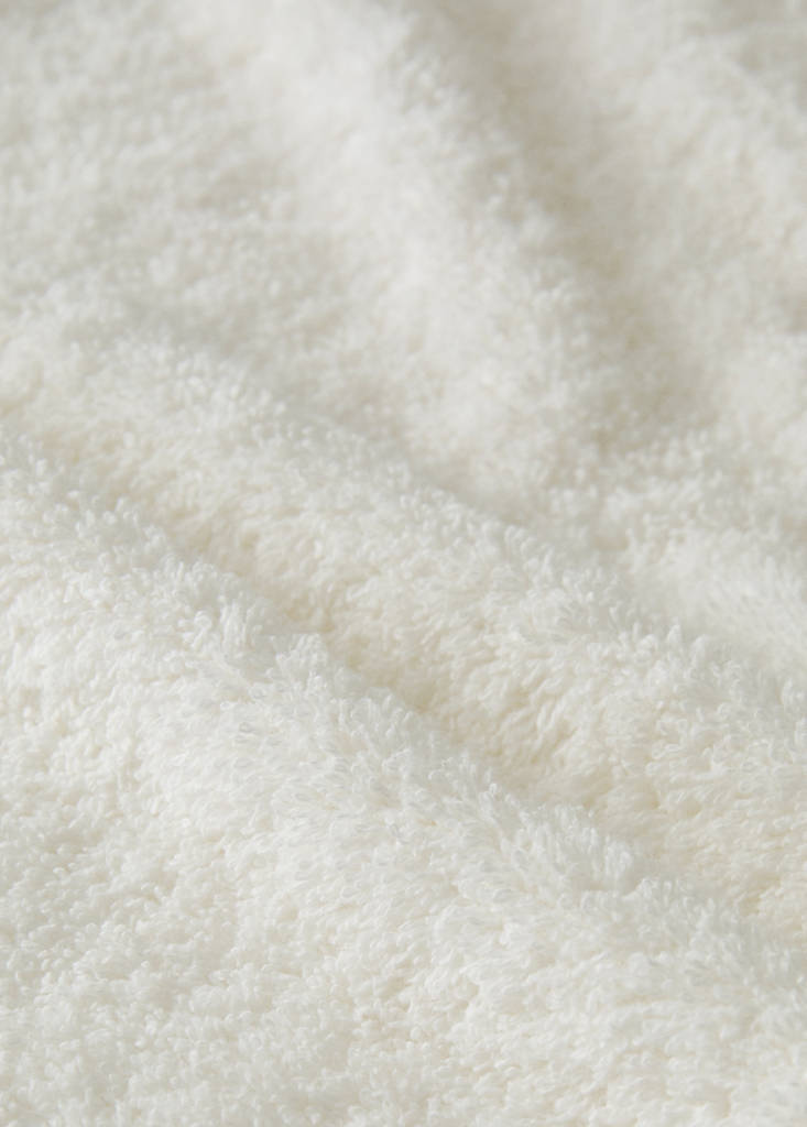 Frayed edge cotton terry hand towel with frill trim — Ecru