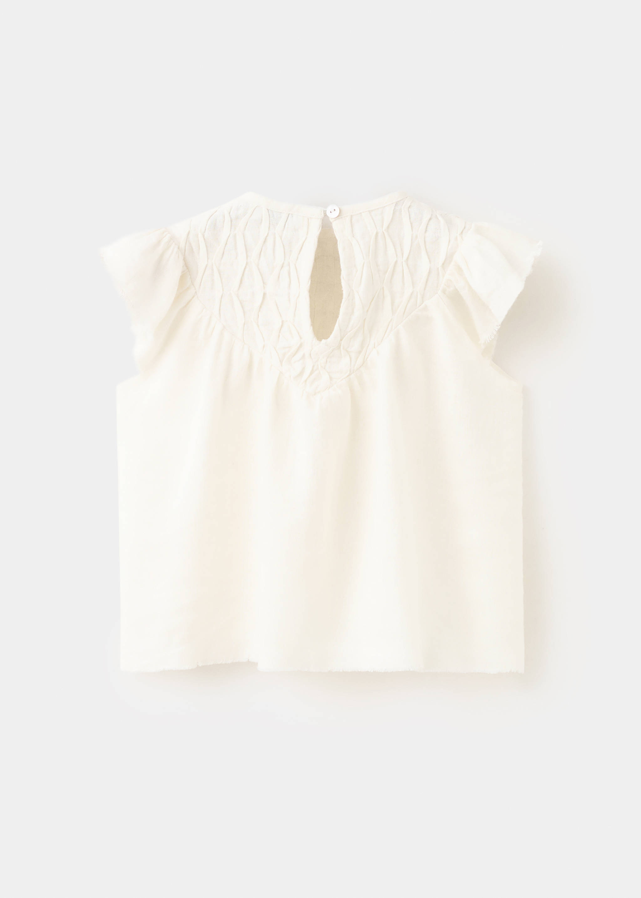 Linen blouse with frayed details - Reverse of the article