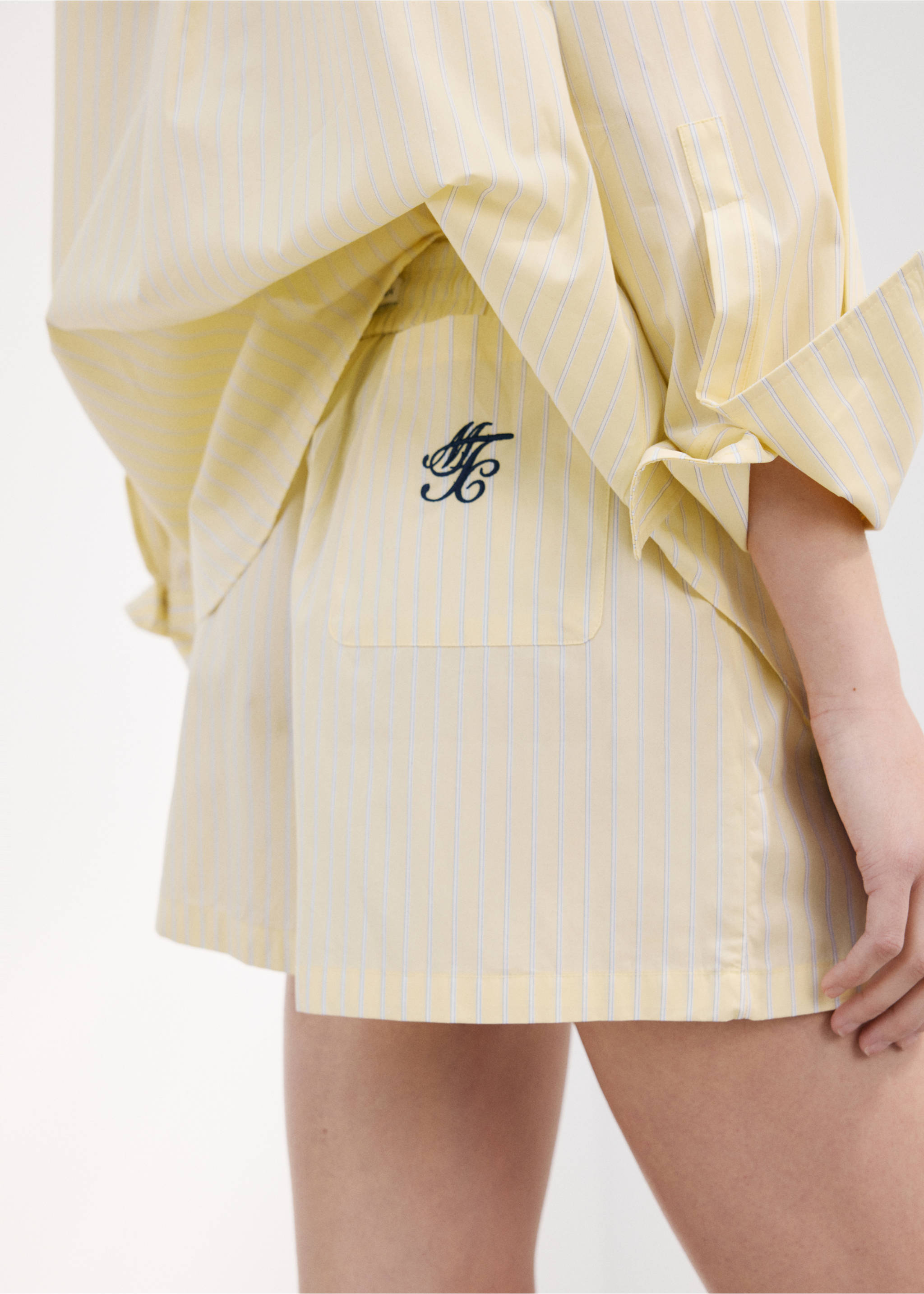 Striped poplin shorts with embroidered message - Details of the article 1, Yellow. Ref: 27077167-00.