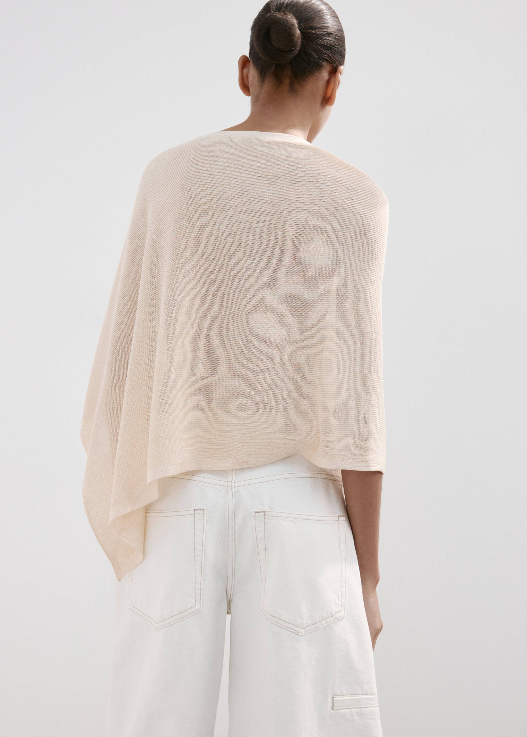Asymmetrical knitted cape - Reverse of the article