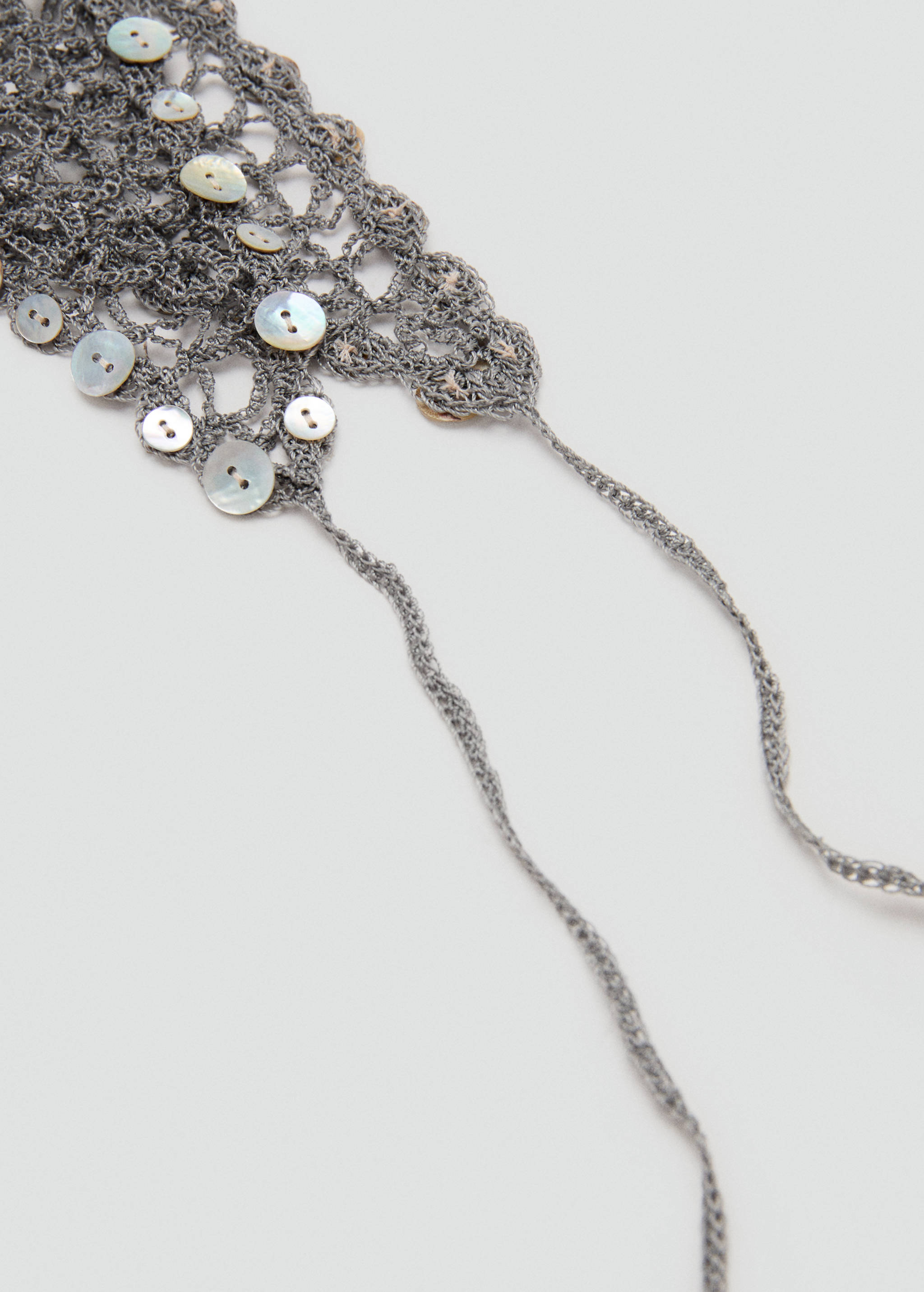 Crochet shawl with decorative buttons - Details of the article 1