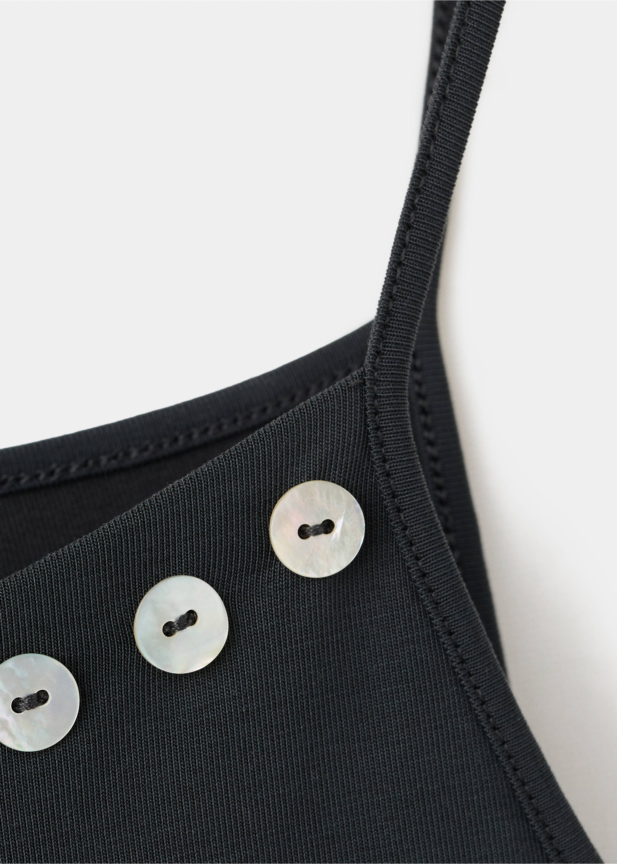 Asymmetric top with embroidered buttons - Details of the article 8, Charcoal. Ref: 27089070-00.