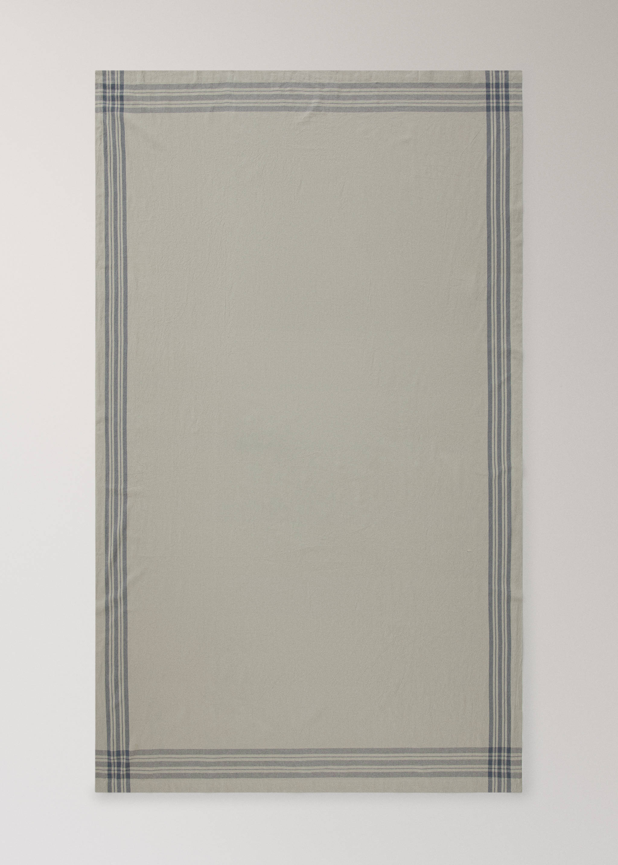 Beige tablecloth with navy striped border detail.