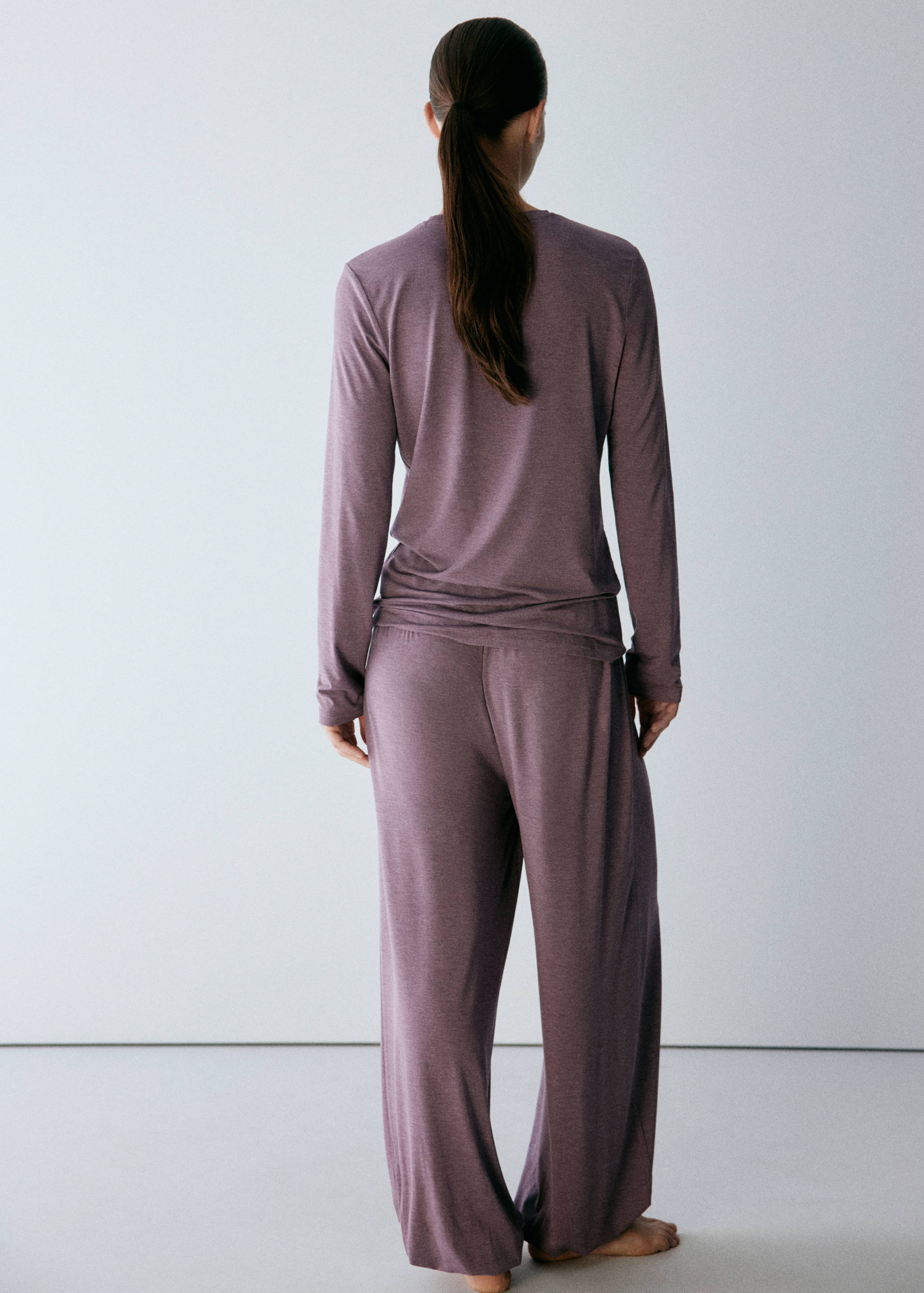 Back view of mauve pyjama trousers with a loose fit.