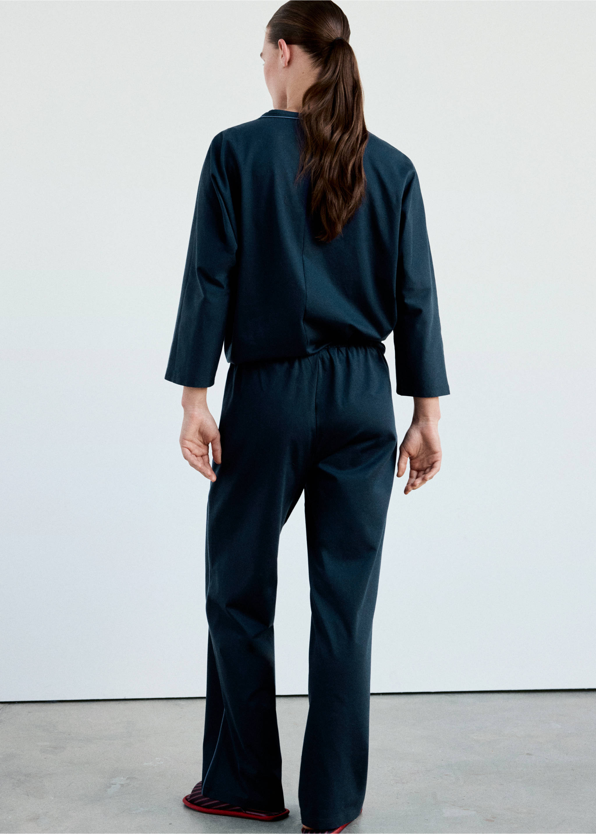 Dark navy blue pyjama trousers worn with a matching top, shown from the back., Navy. Ref: 37002929-00.