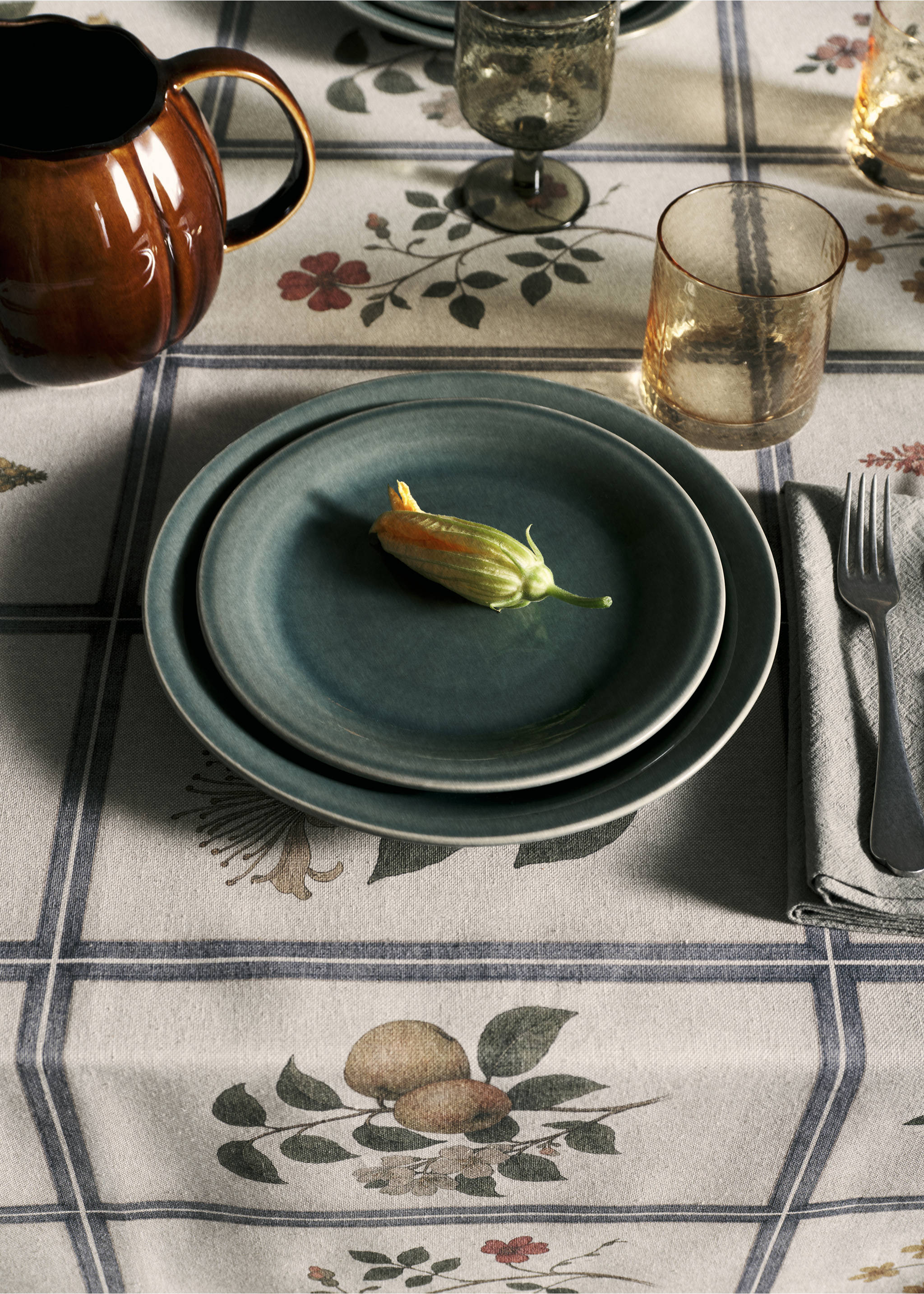 Set of dark green ceramic plates on a patterned tablecloth., Forest Green. Ref: 37003326-00.