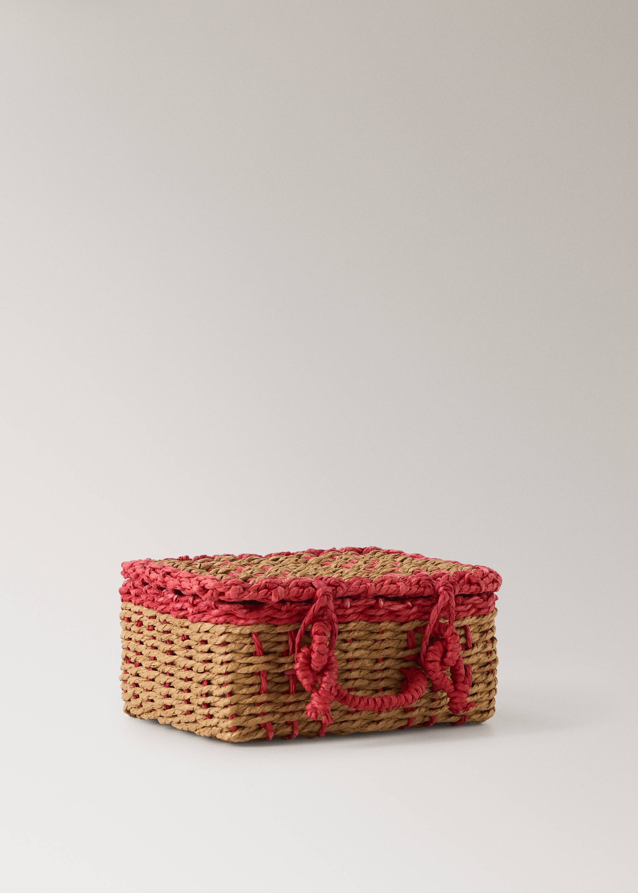 Rectangular woven basket in natural brown with vibrant red woven trim and fastening details.