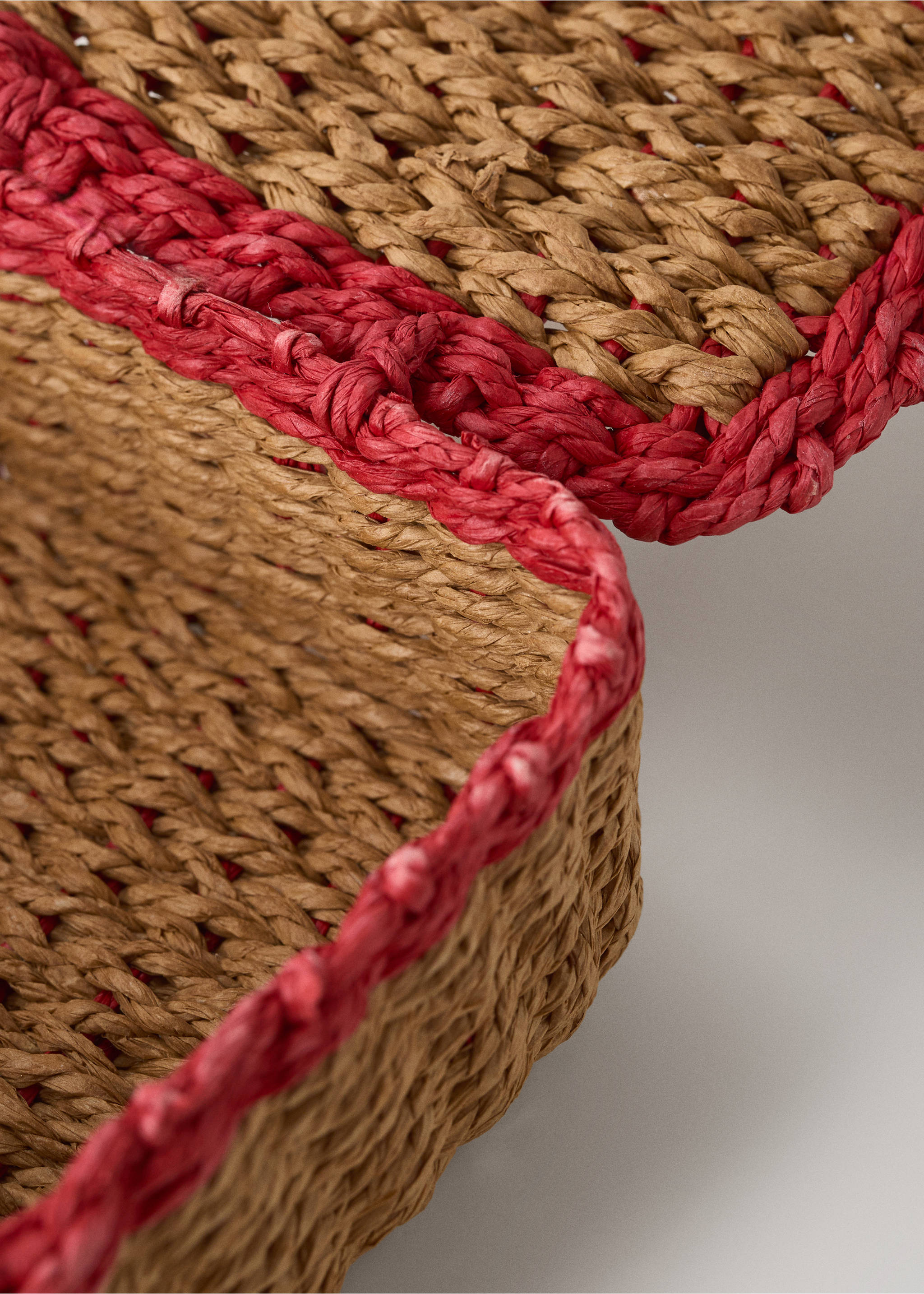 Close-up of a woven natural basket with red trim., Off White. Ref: 37004458-00.