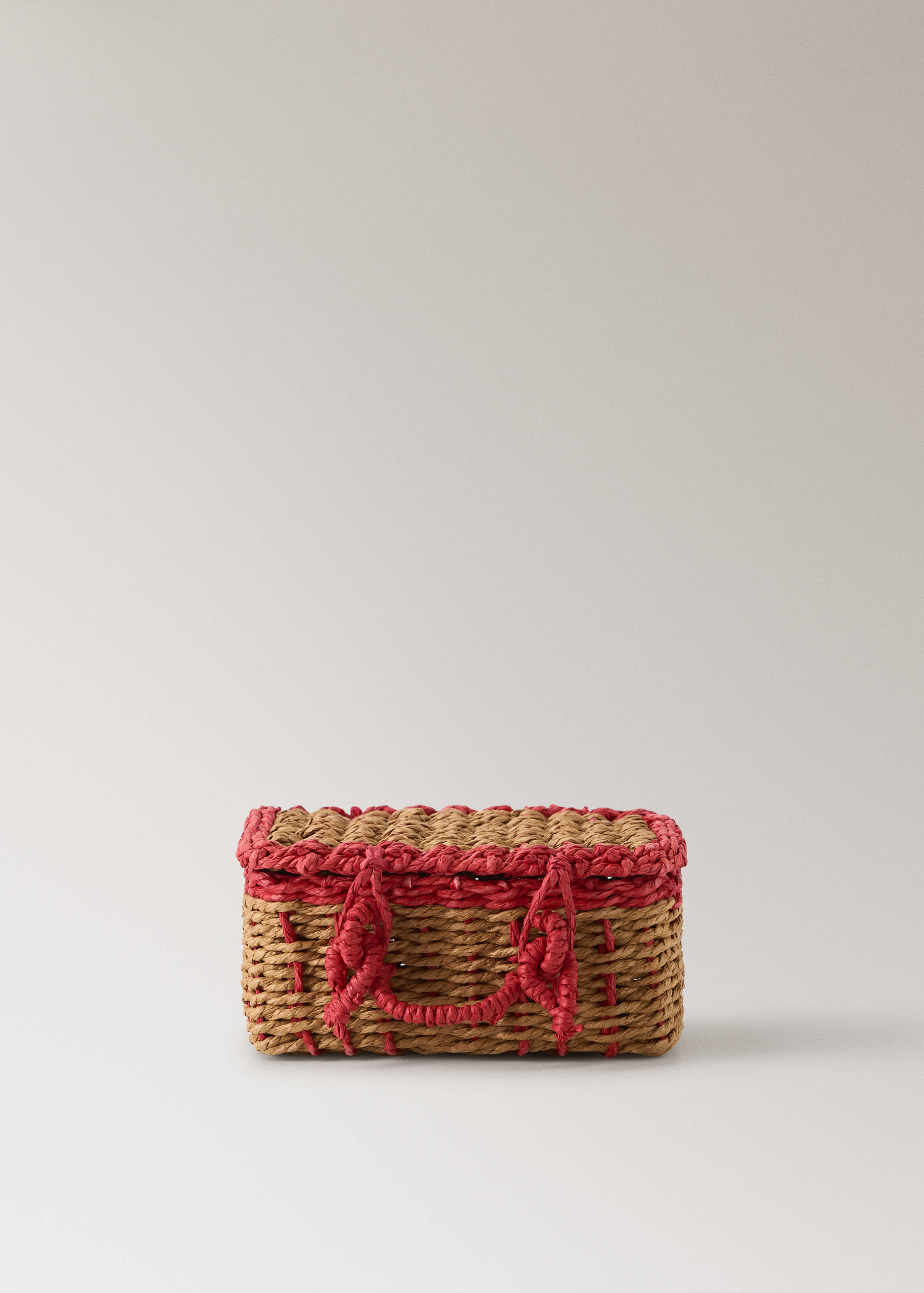 Brown and pink woven basket with a lid and short handles.