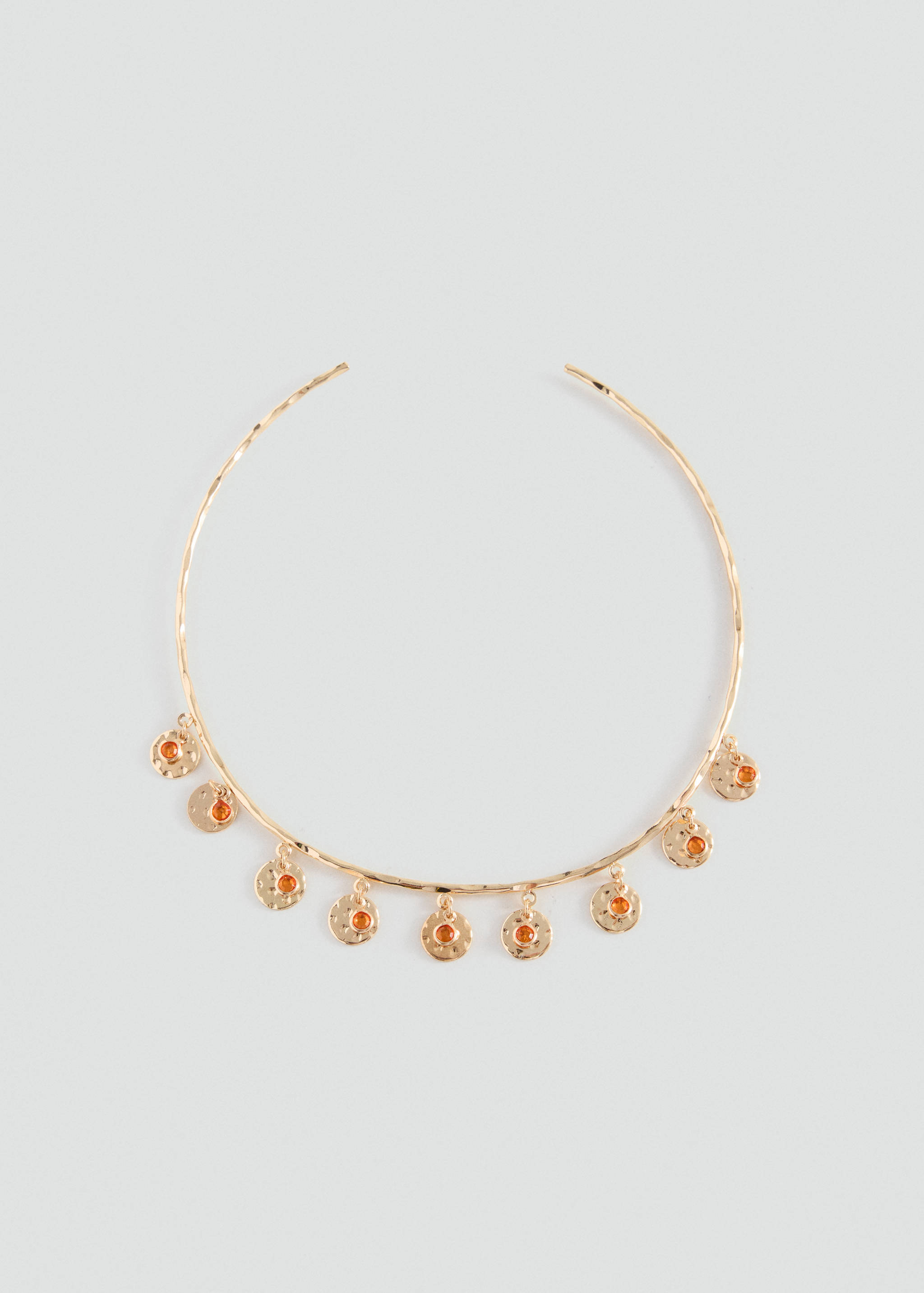 Gold-tone rigid collar necklace with hanging textured disc charms inset with orange stones.
