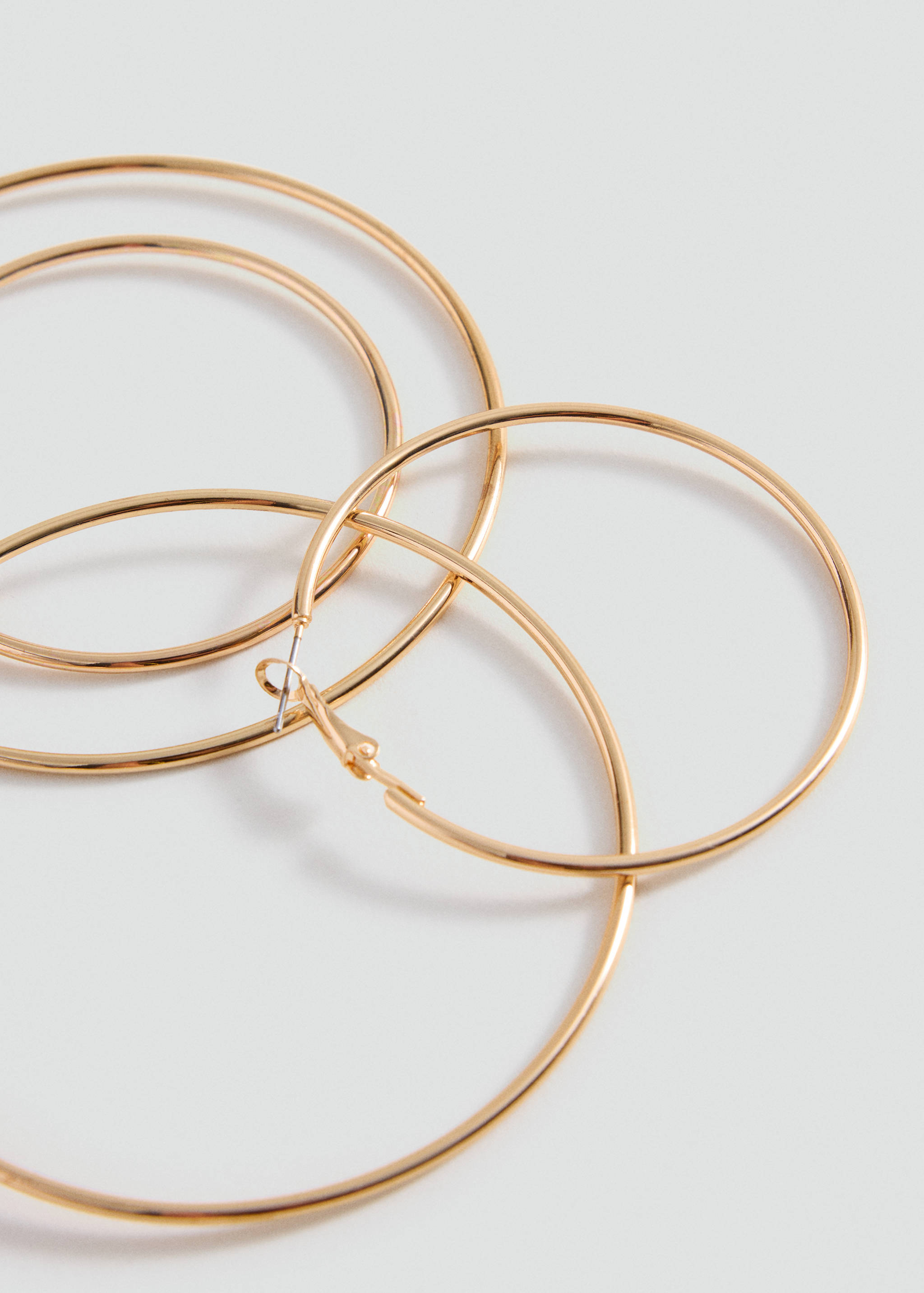 Set of shiny gold-toned hoop earrings.