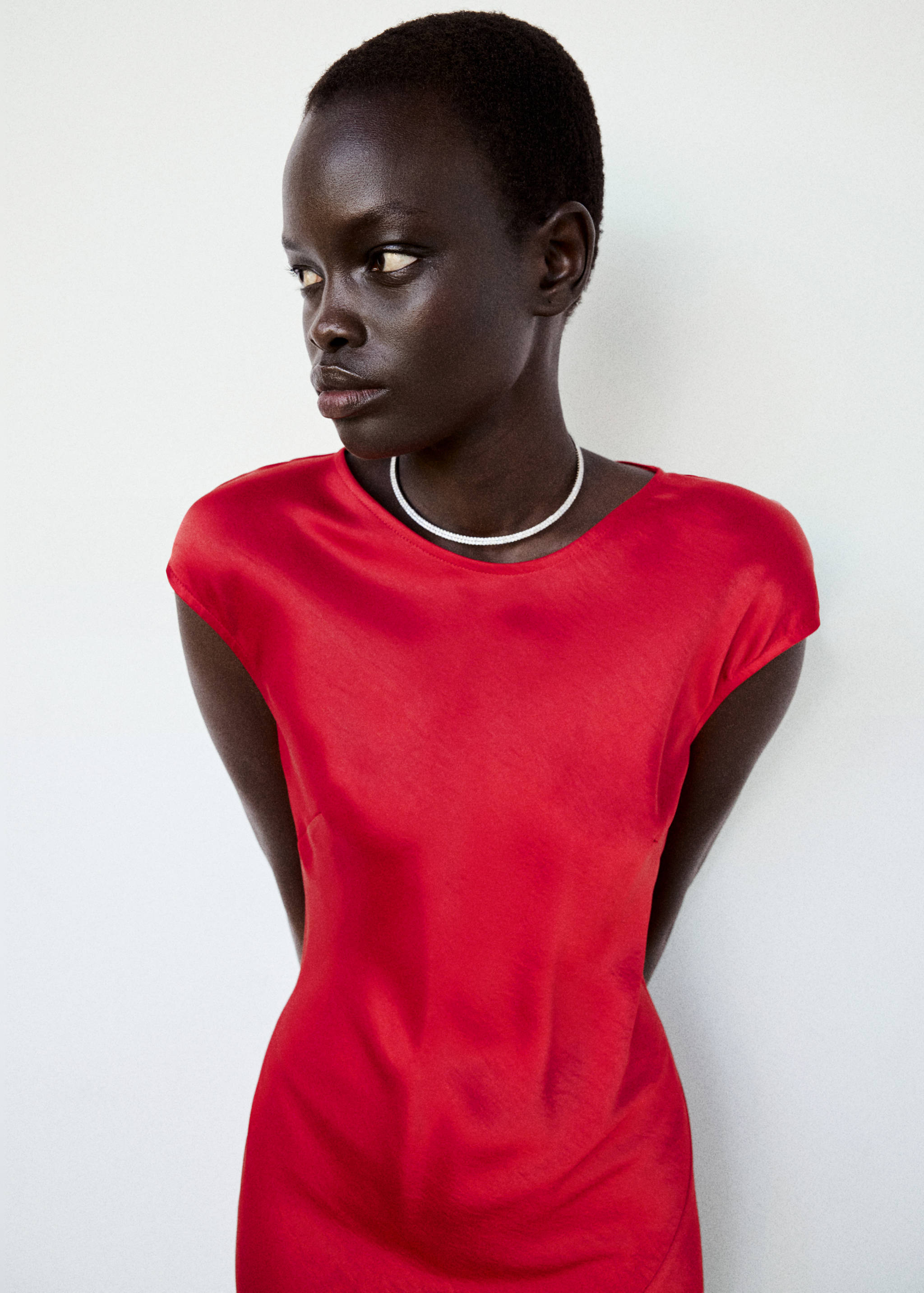 Red sleeveless dress with a rounded neckline and fitted silhouette.