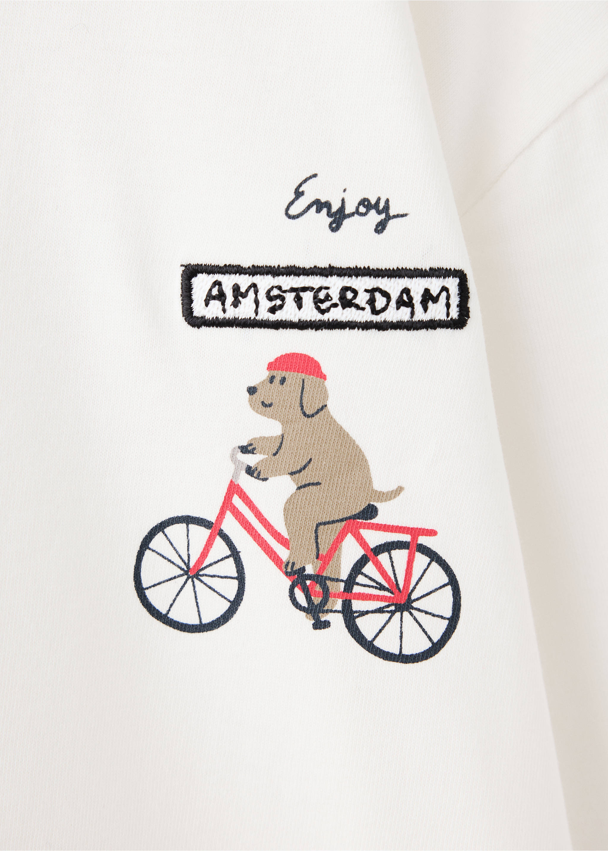 Close-up of a kids white t-shirt with an embroidered dog riding a bike., Off White. Ref: 37006335-00.