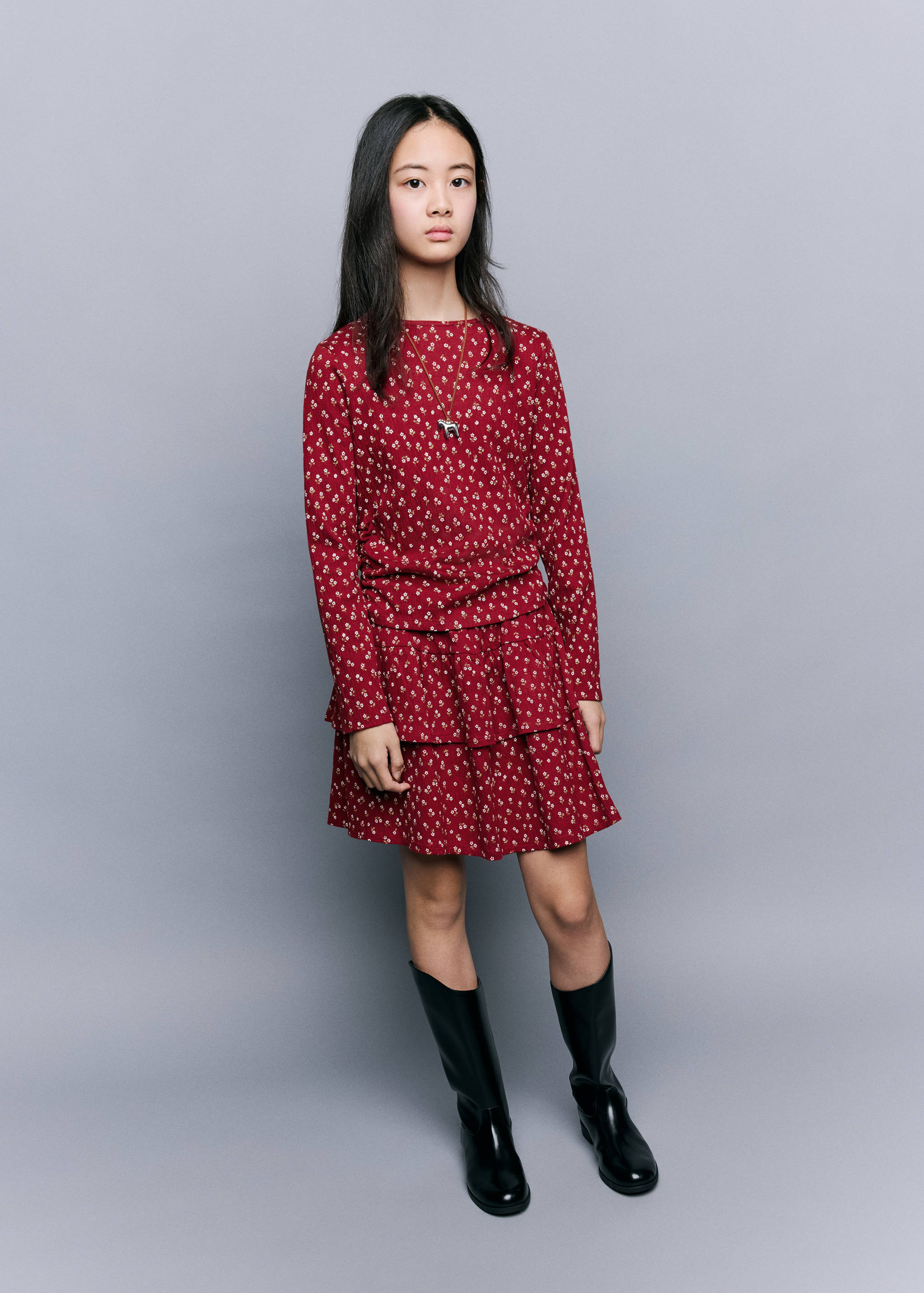 Red floral long-sleeve t-shirt with matching tiered skirt, worn with a necklace.