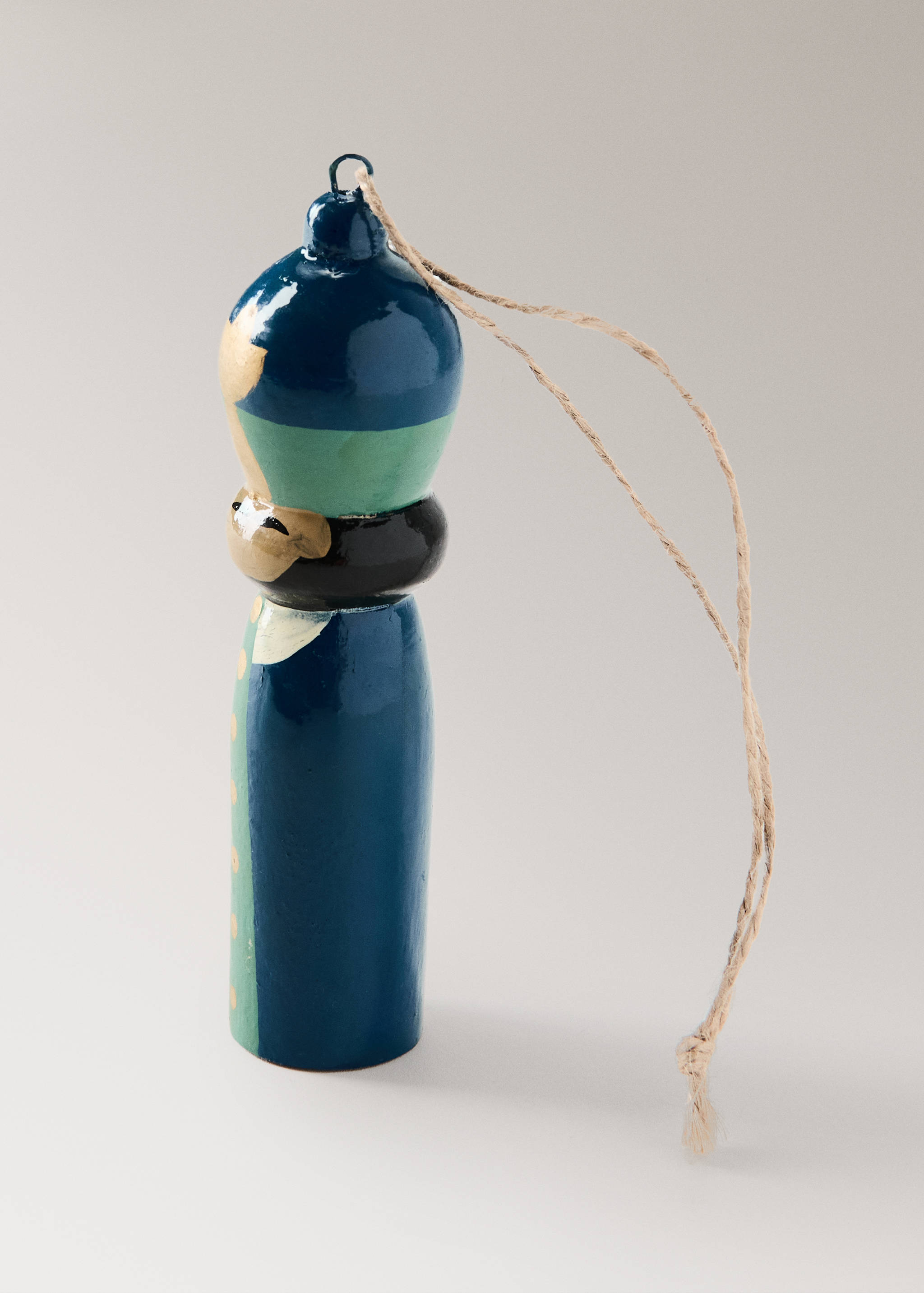 Nutcracker Christmas ornament in blue wood with hanging twine.