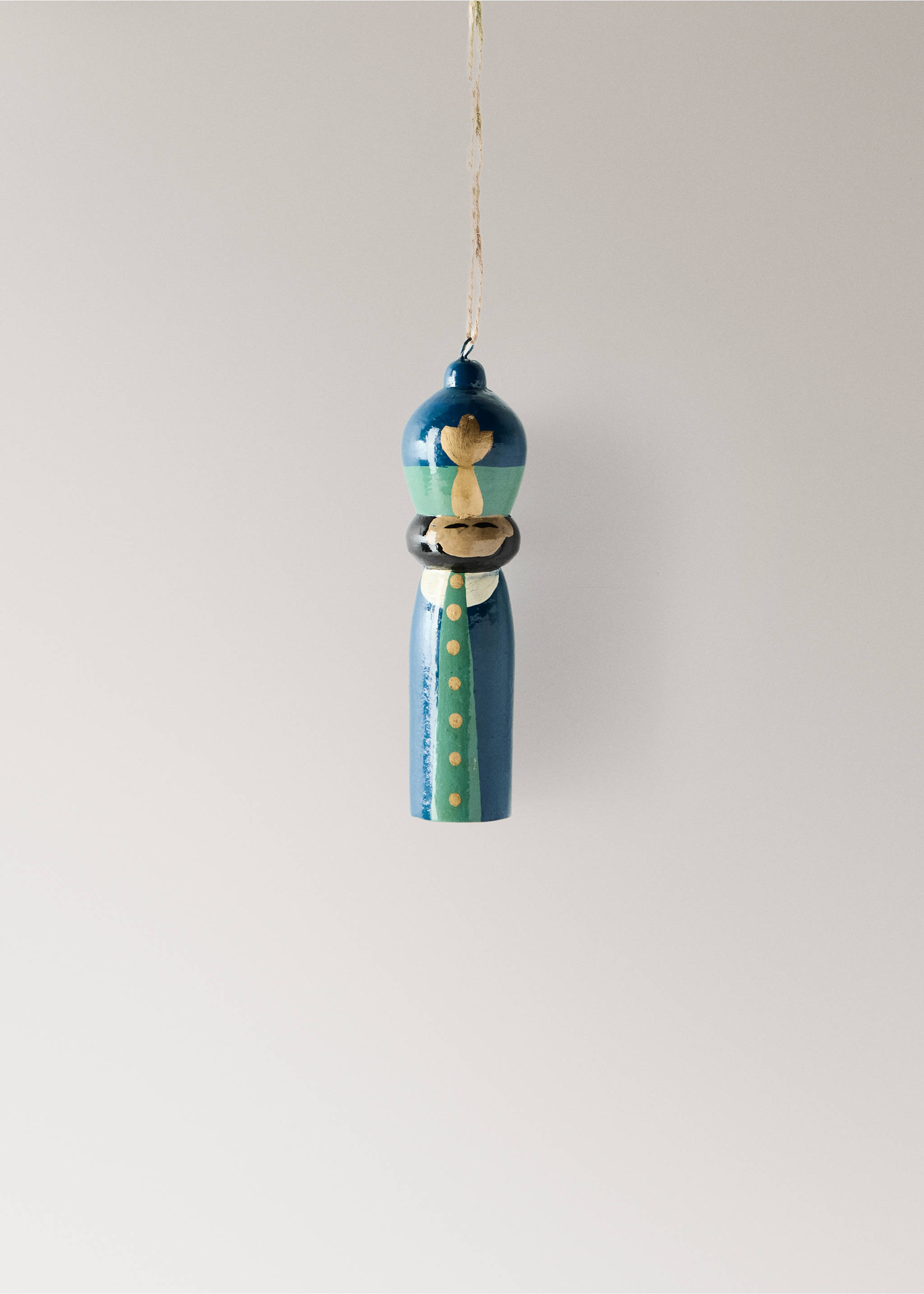 Blue and green wooden nutcracker Christmas ornament hanging from a twine string., Blue. Ref: 37006741-00.