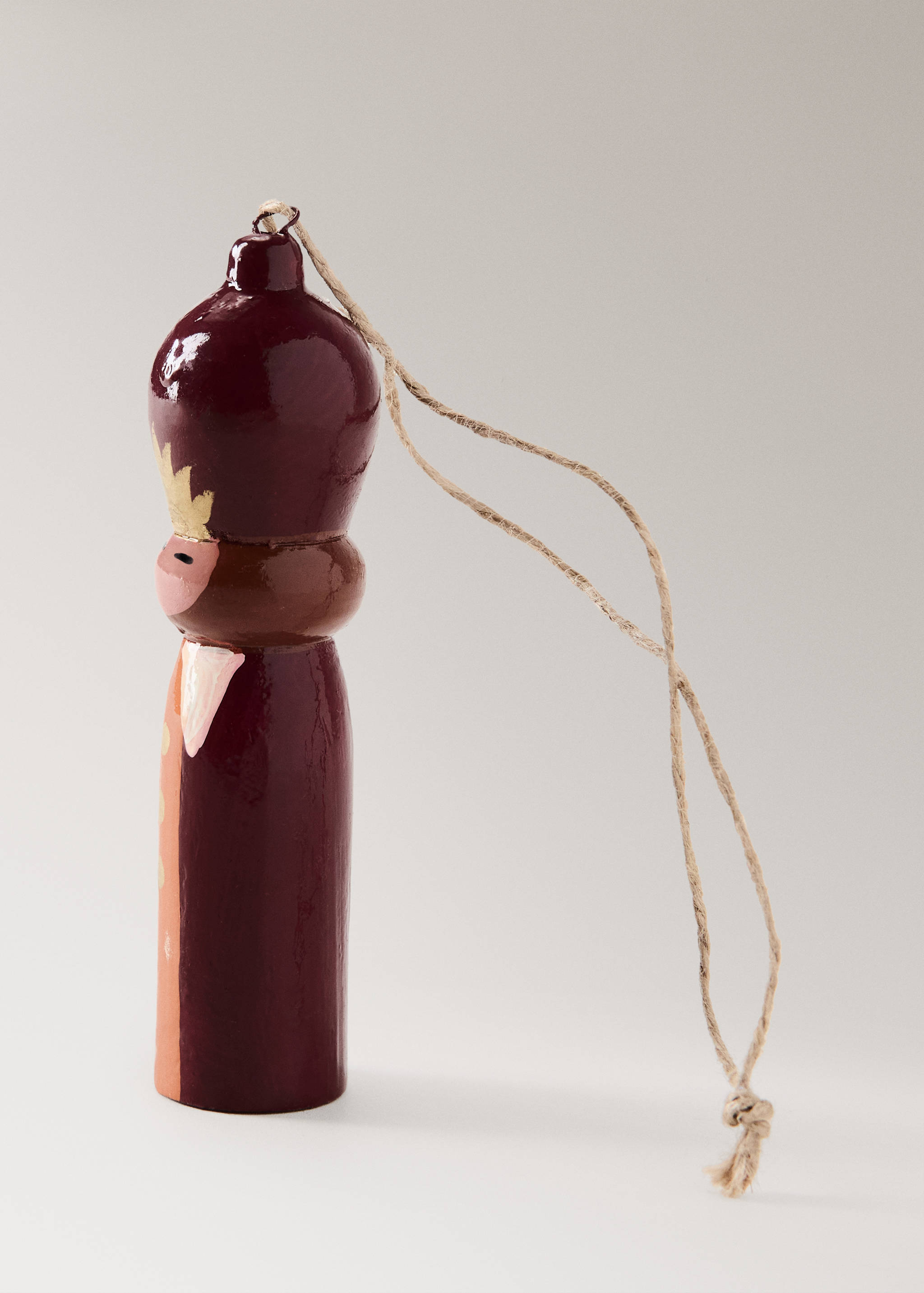Burgundy wooden nutcracker Christmas ornament with twine hanging loop.