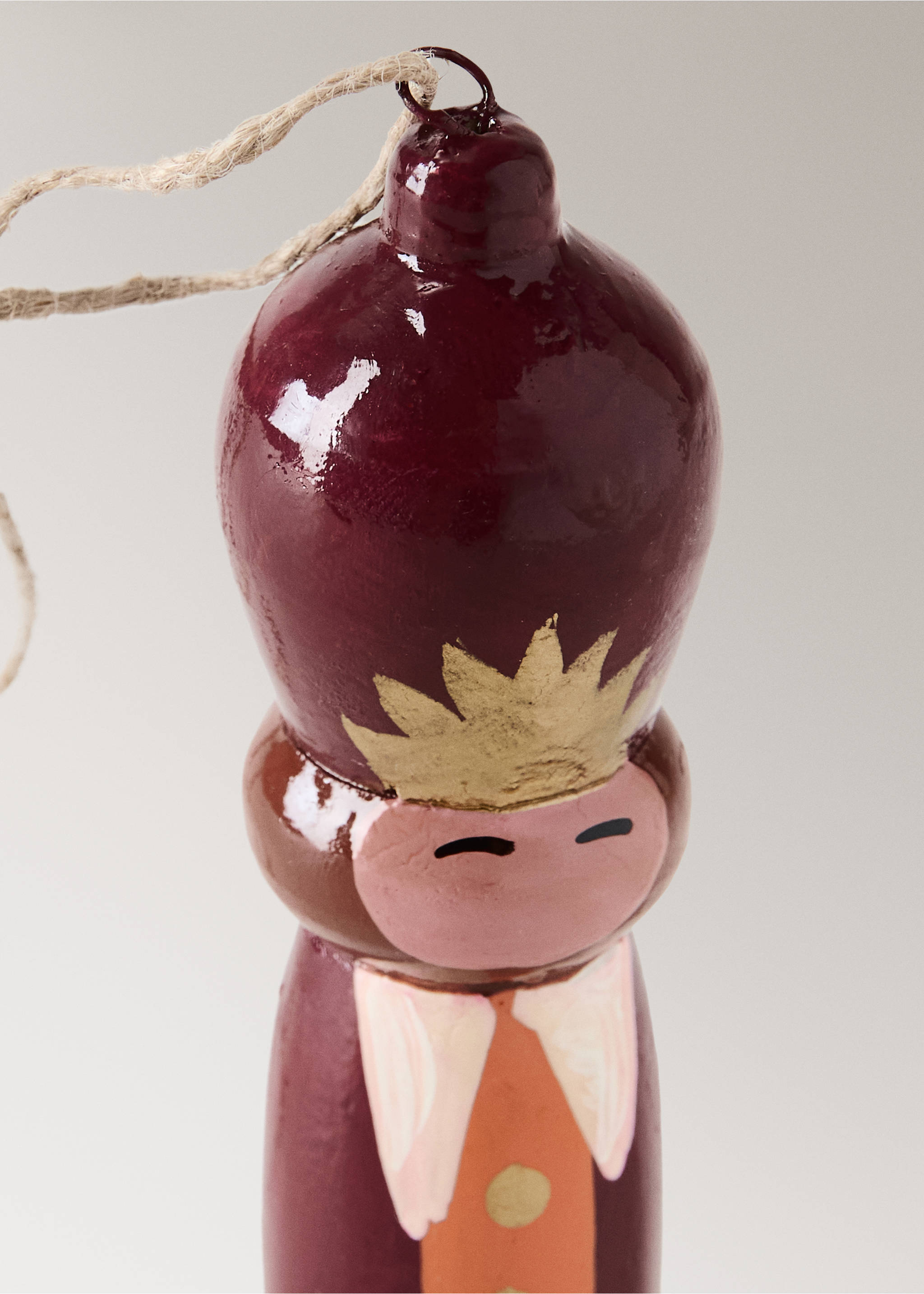 Burgundy wooden Christmas ornament featuring a gold crown and painted facial details., Red. Ref: 37006742-00.