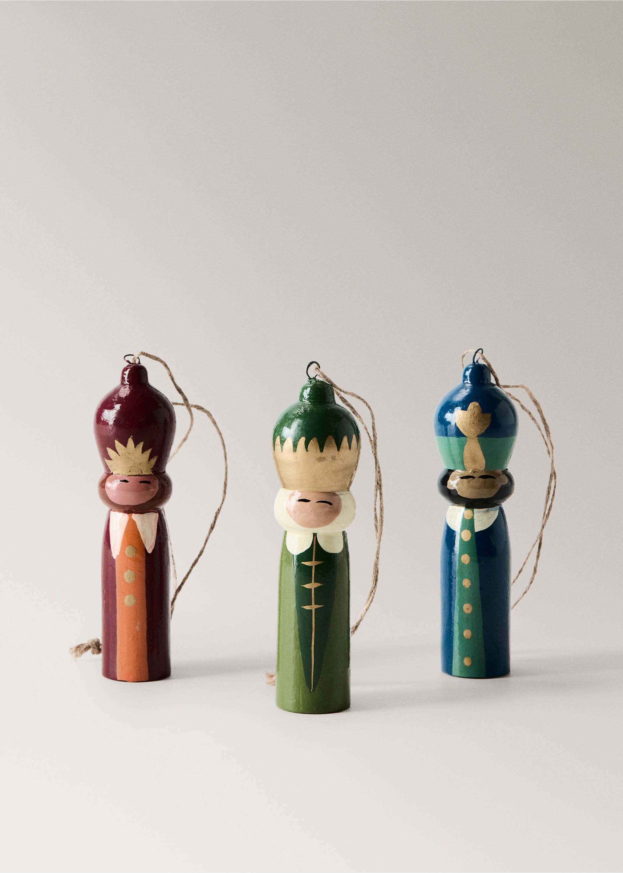 Three glossy wooden Christmas ornaments shaped like painted figures with twine hanging loops., Red. Ref: 37006742-00.