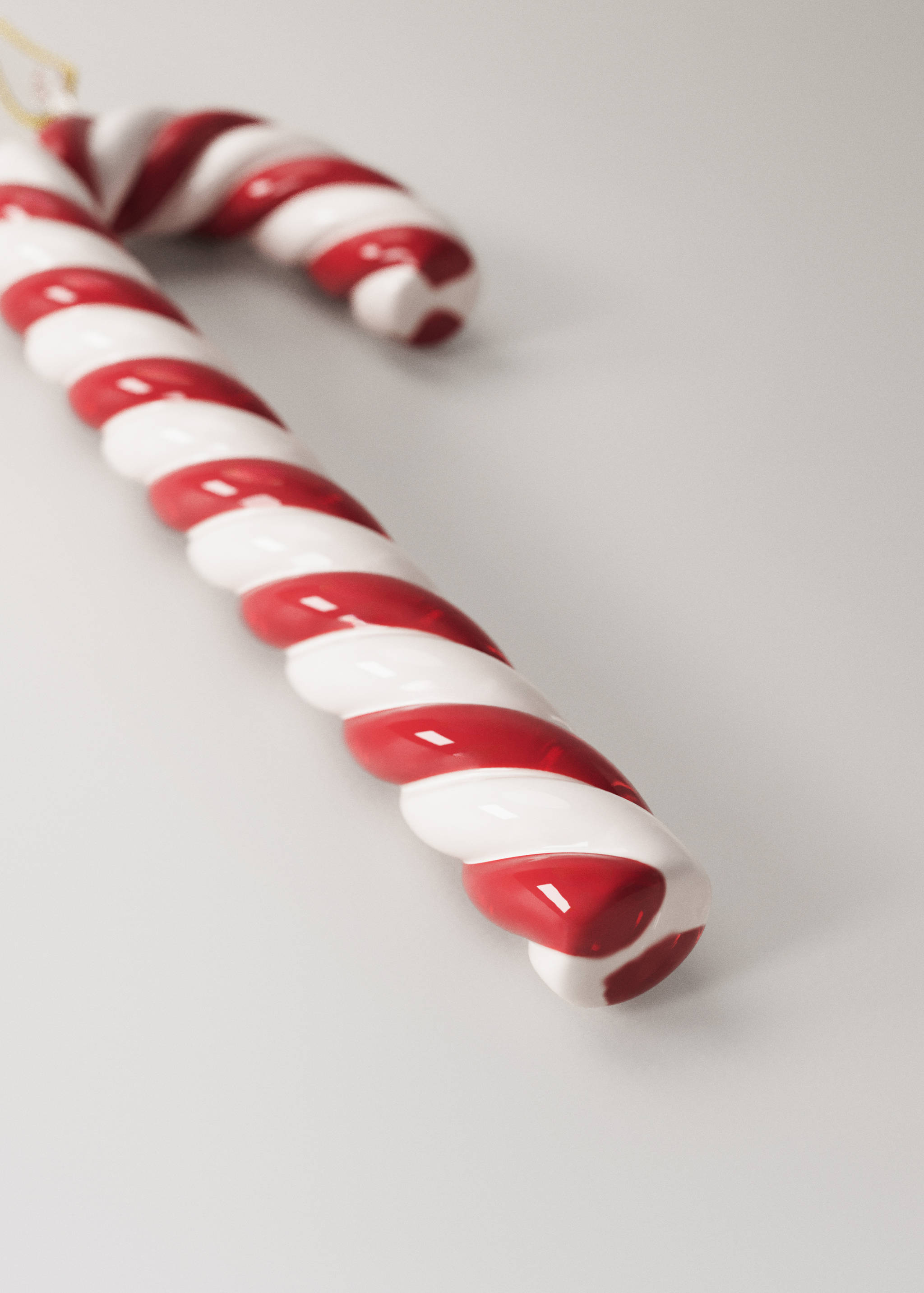 Glossy red and white striped candy cane Christmas ornament.