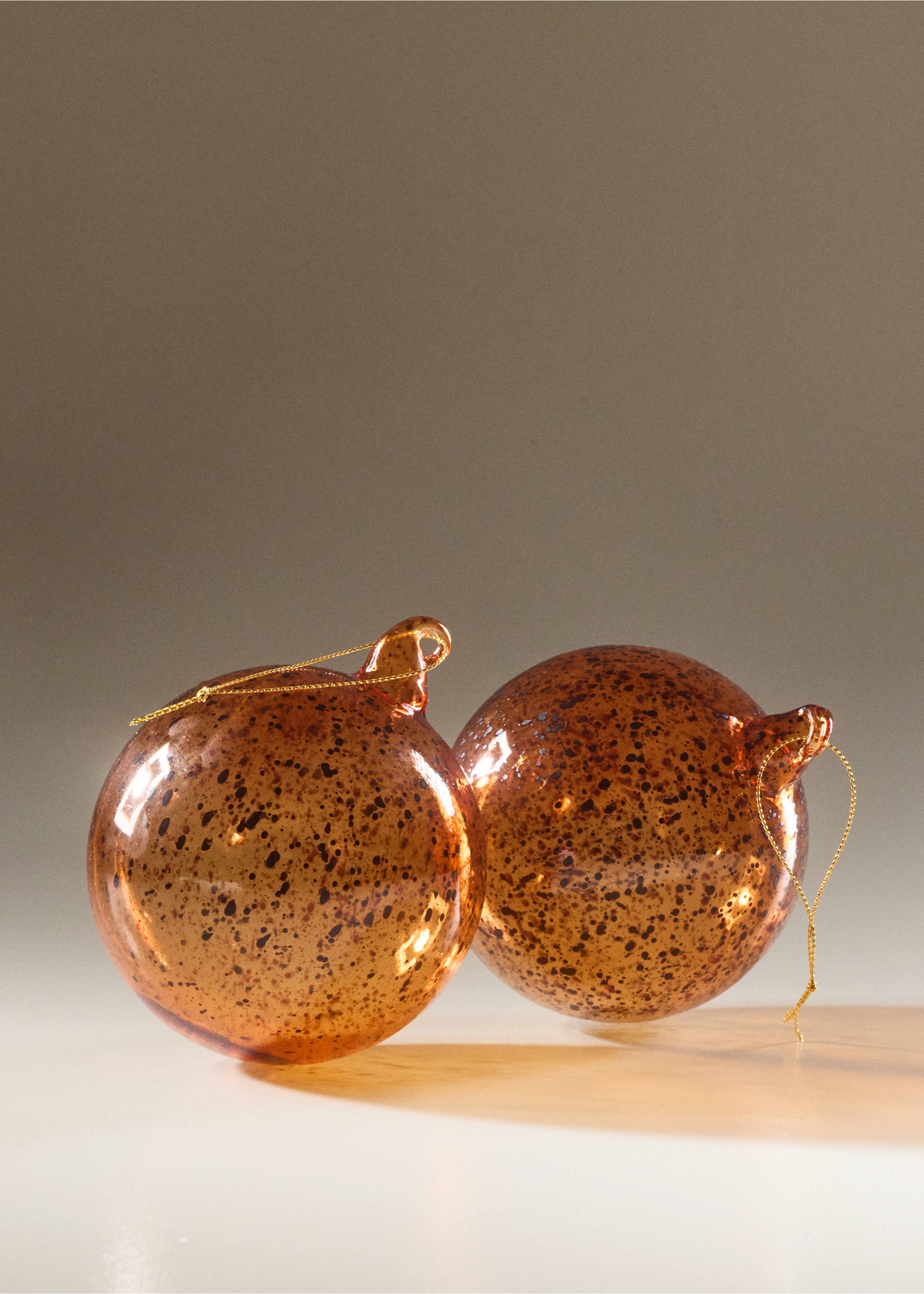Amber speckled glass Christmas ornaments with gold hanging cords., Ochre. Ref: 37006745-00.