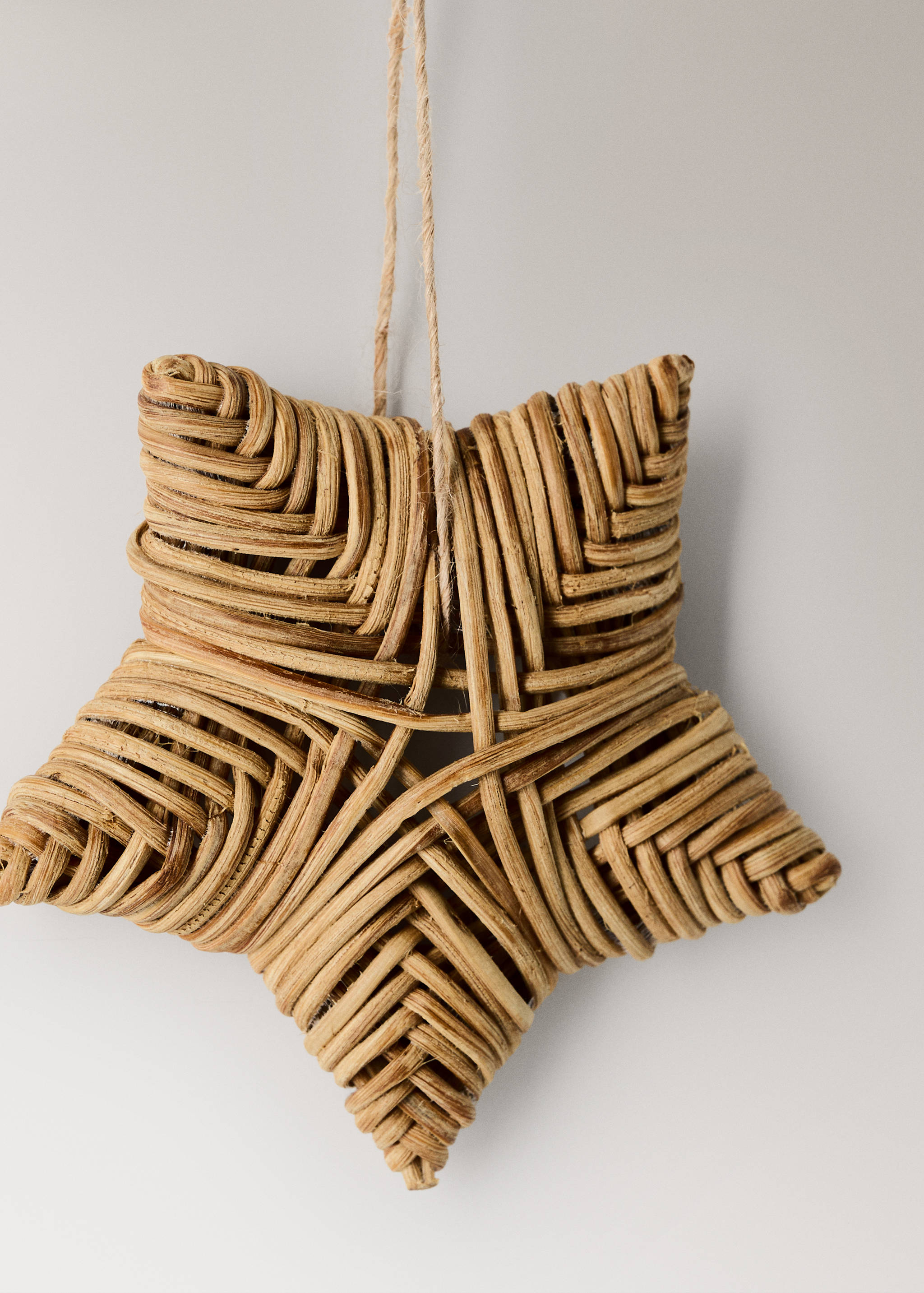 Woven rattan star Christmas decoration with a jute hanging loop.