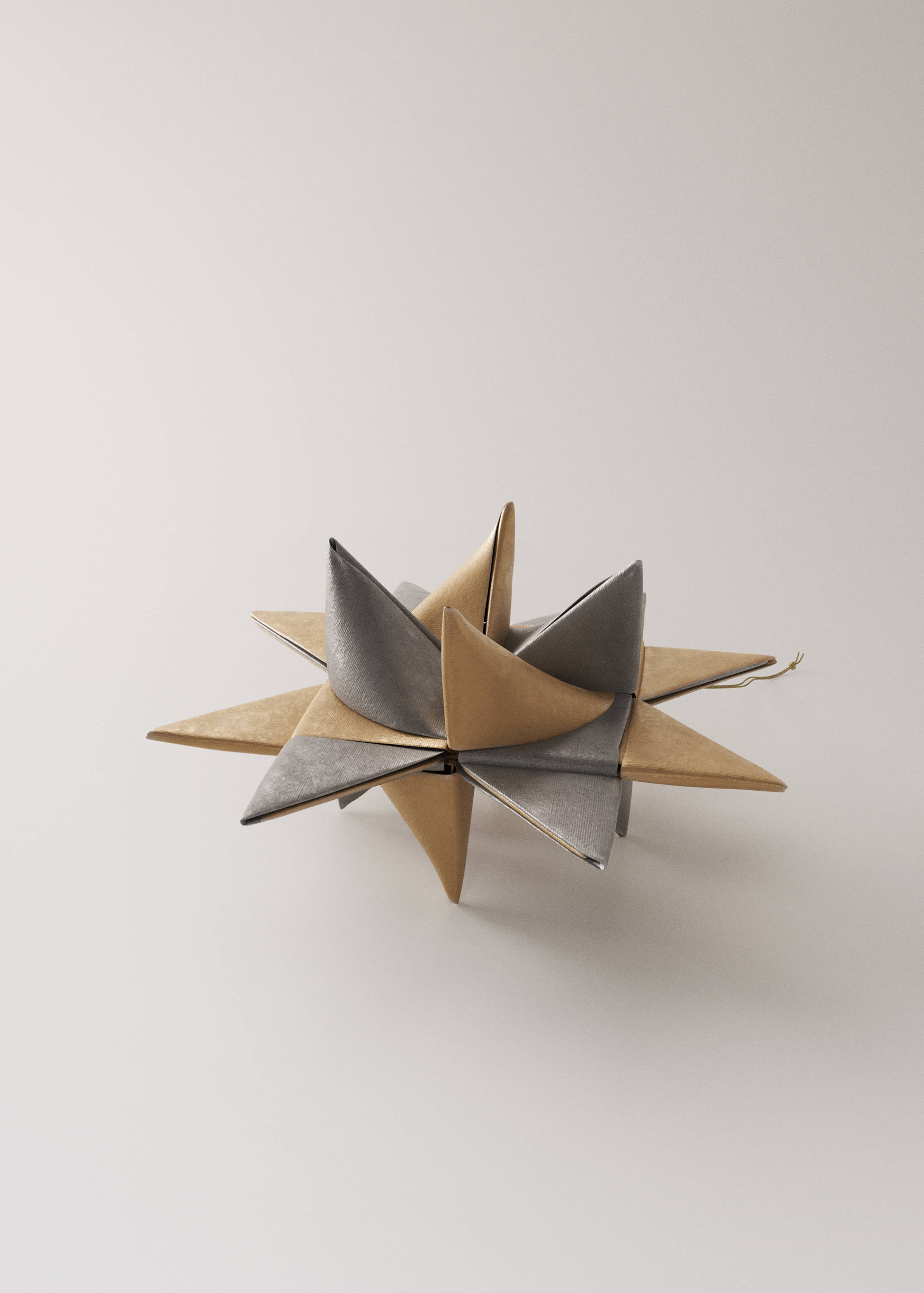 Two metallic gold and silver star Christmas ornaments.