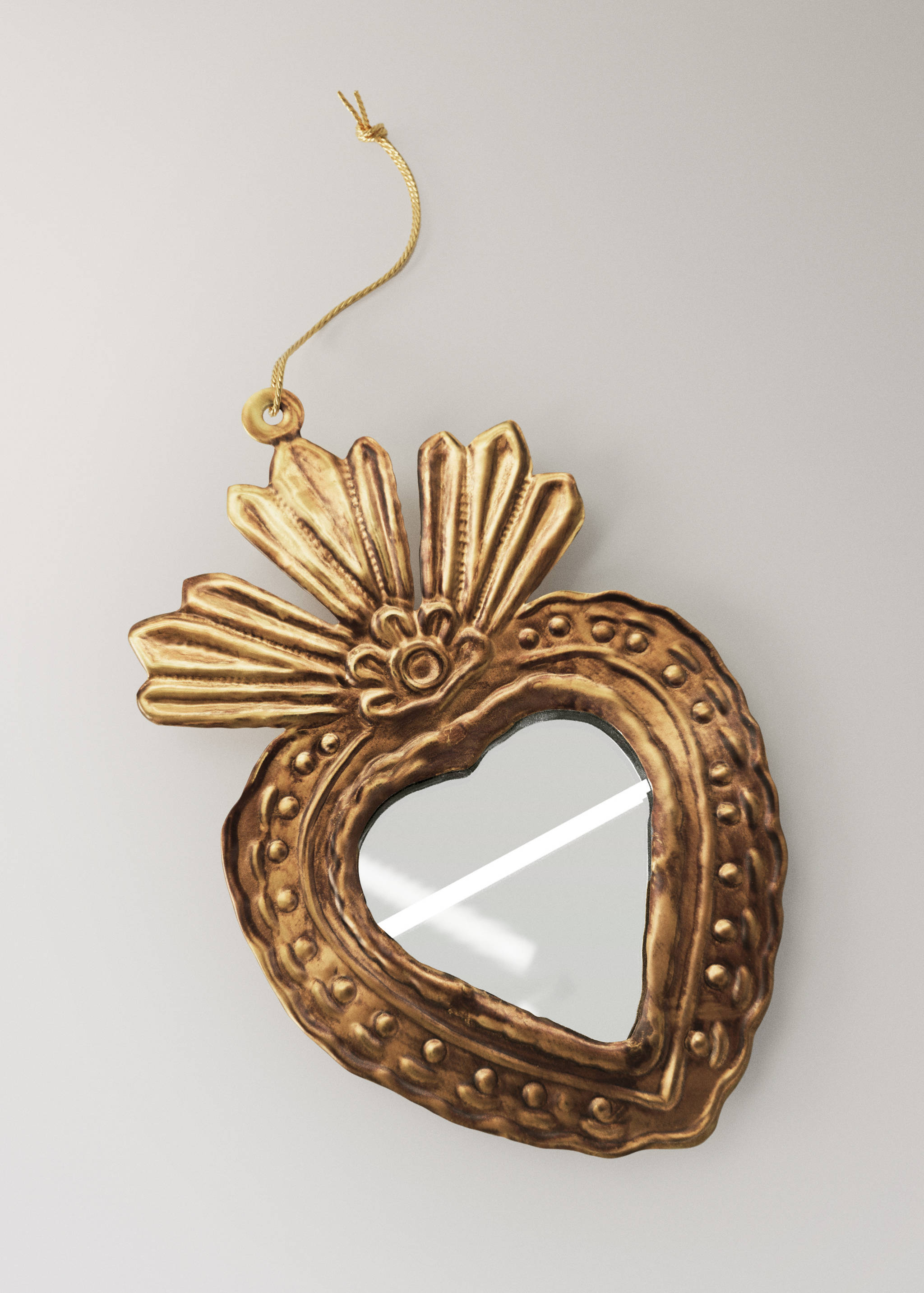 Gold heart-shaped Christmas ornament with embossed texture and a hanging string.