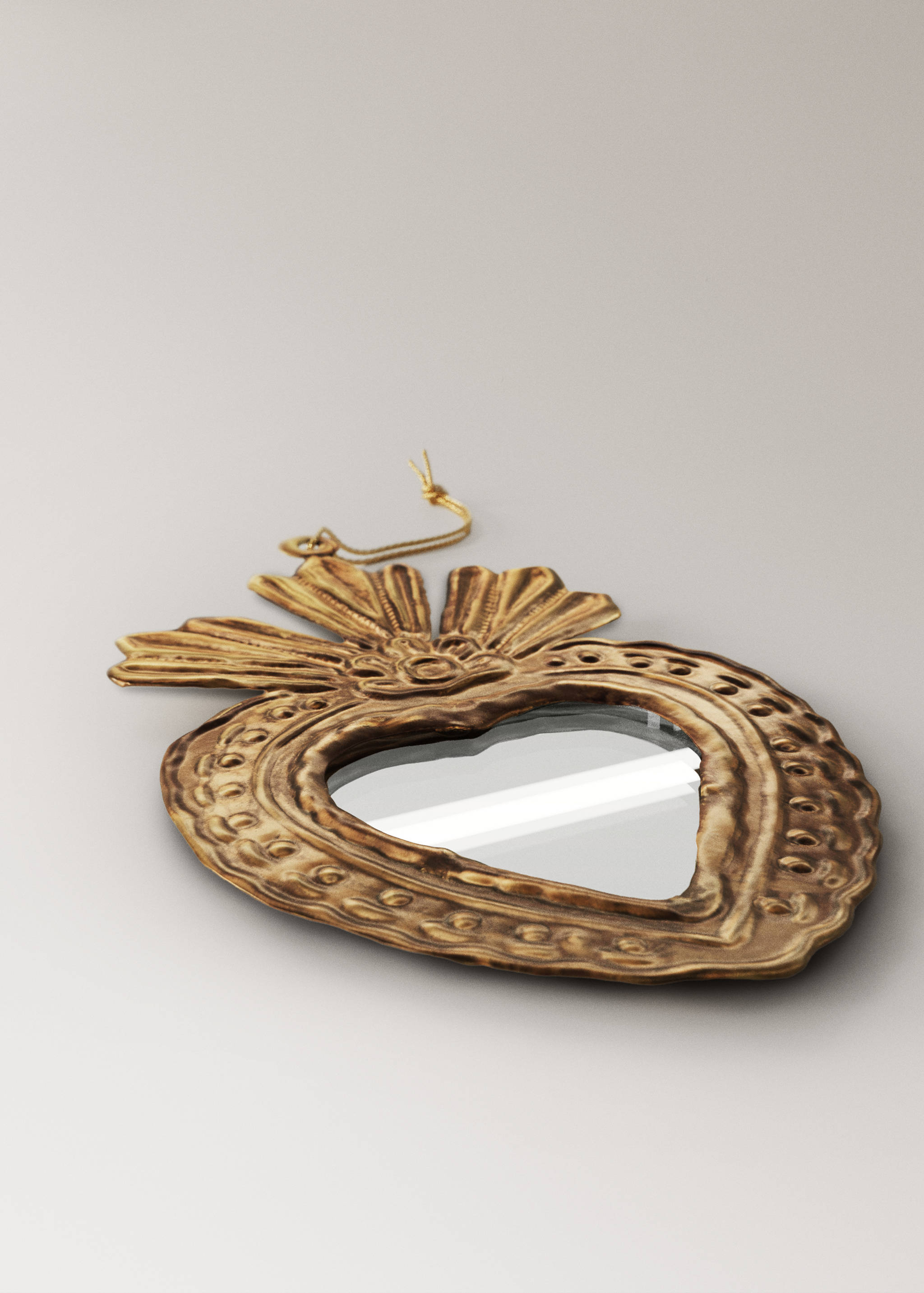 Gold metallic sacred heart Christmas ornament with mirror inset.