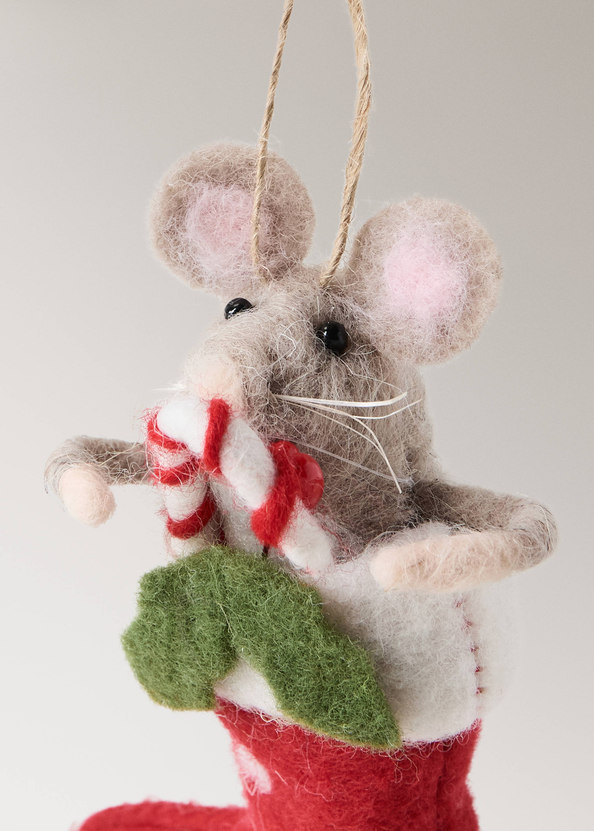 Felt mouse Christmas ornament holding a candy cane in a red stocking.