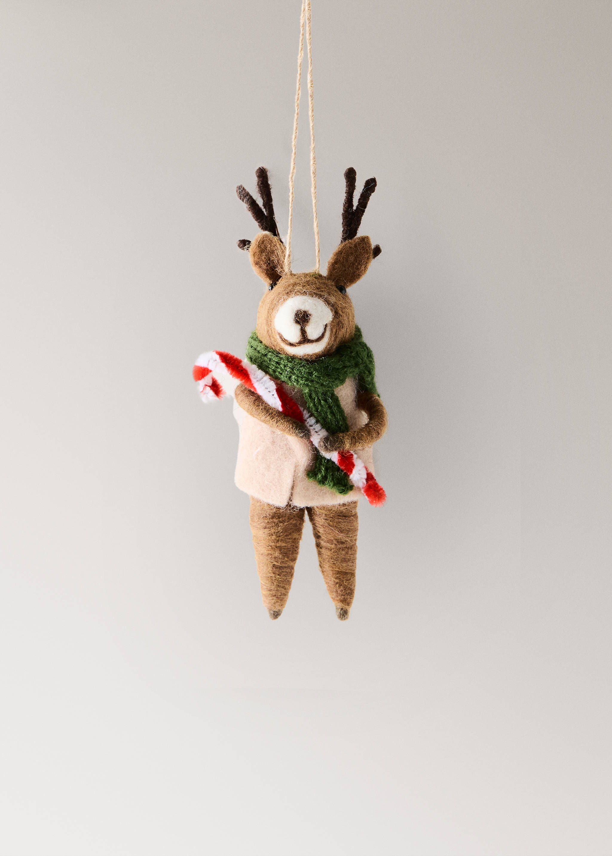 Felt reindeer Christmas ornament with scarf and candy cane.