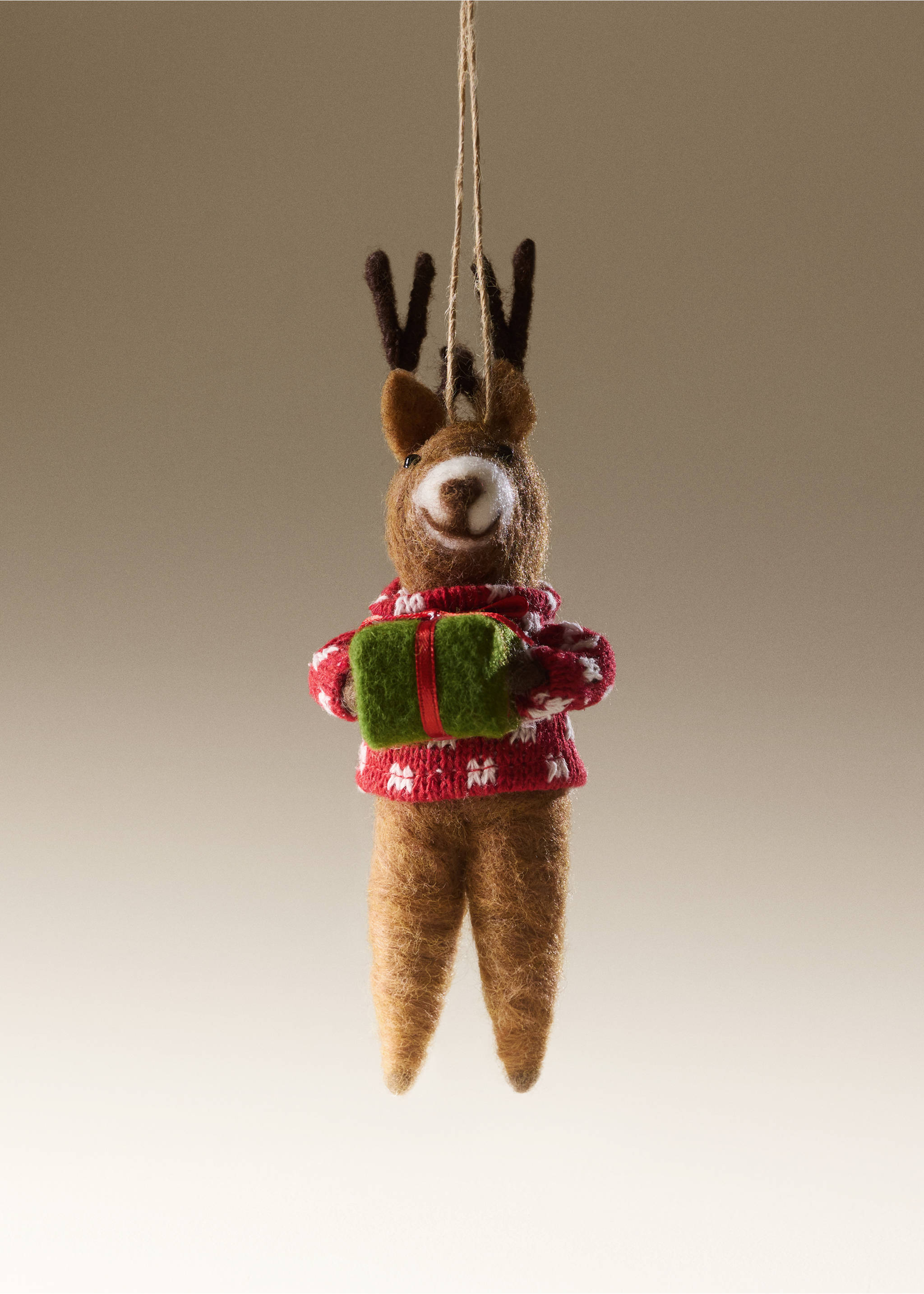 Felt reindeer Christmas ornament holding a green gift and wearing a red patterned sweater., Red. Ref: 37006795-00.