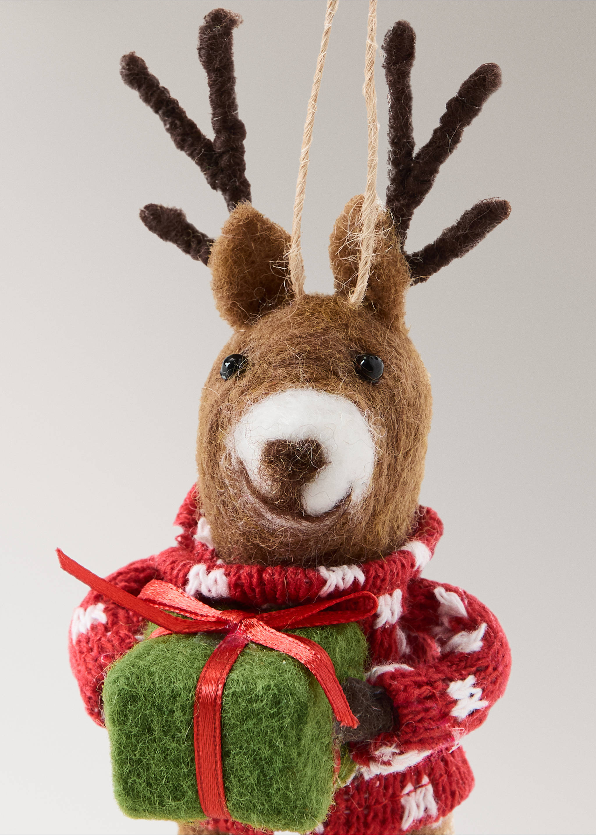 Felt reindeer Christmas ornament holding a green gift box and wearing a red Nordic pattern jumper., Red. Ref: 37006795-00.