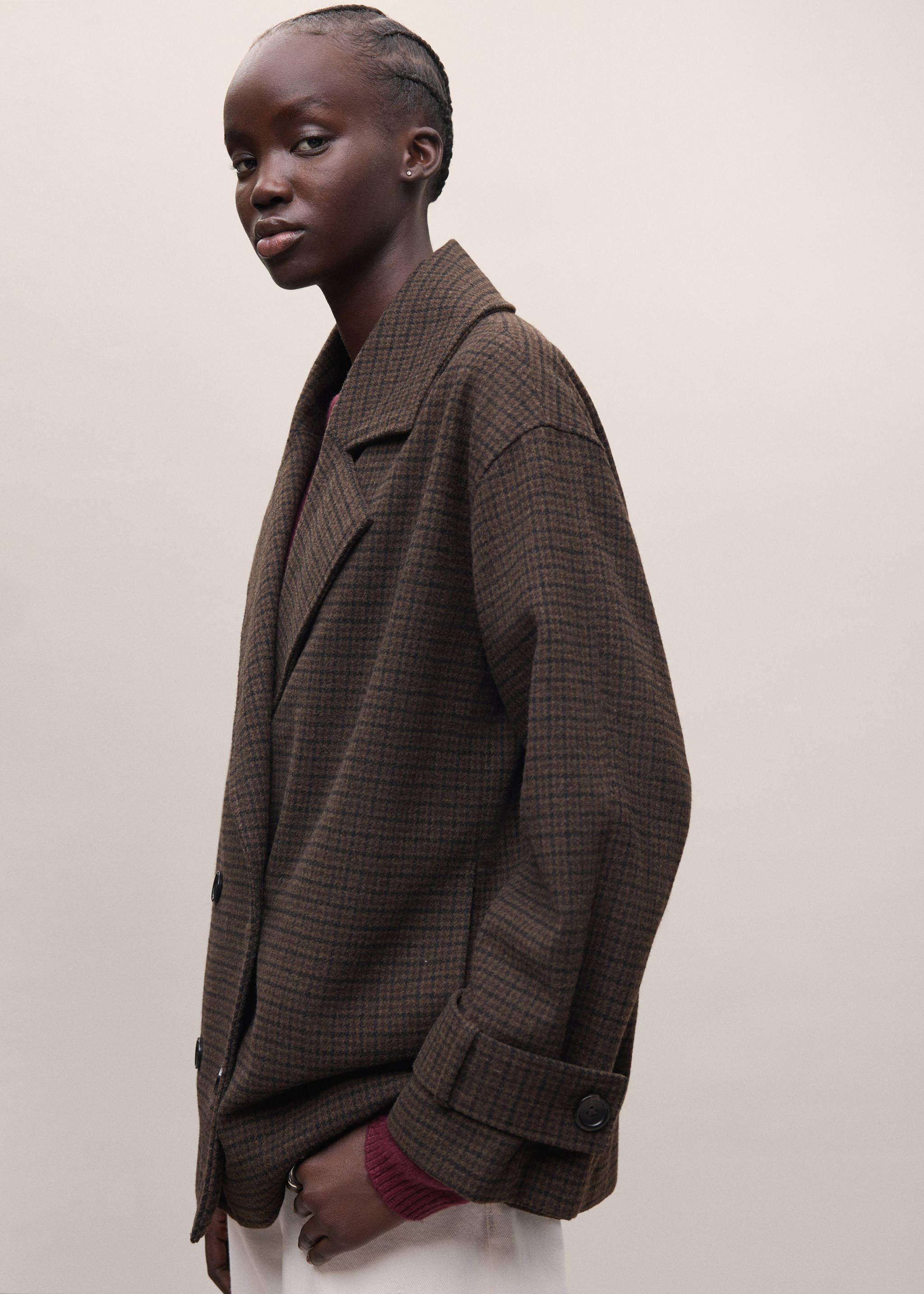 Brown houndstooth coat with lapel collar and button tabs