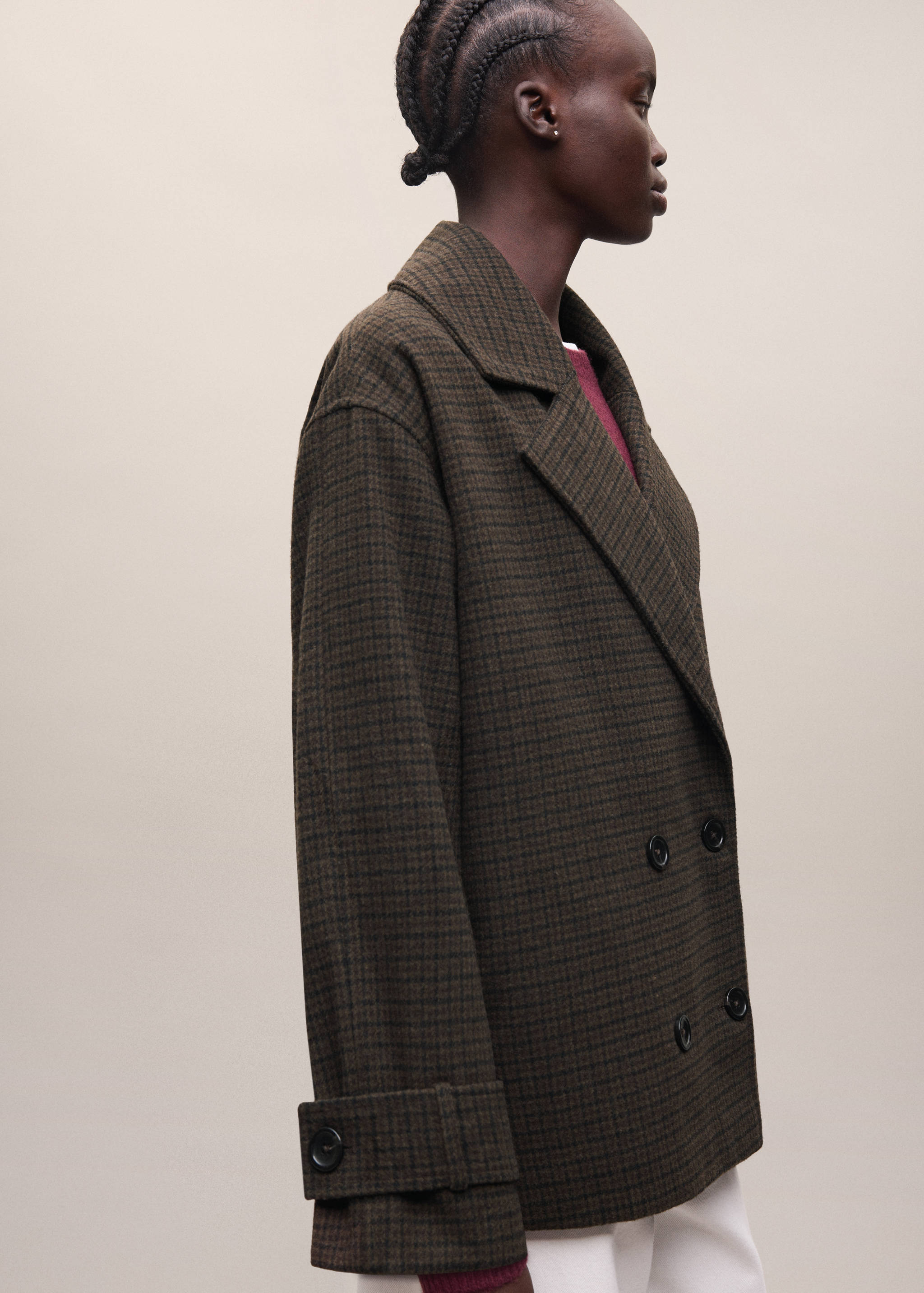 Brown check double-breasted coat with lapels and buttoned cuffs.